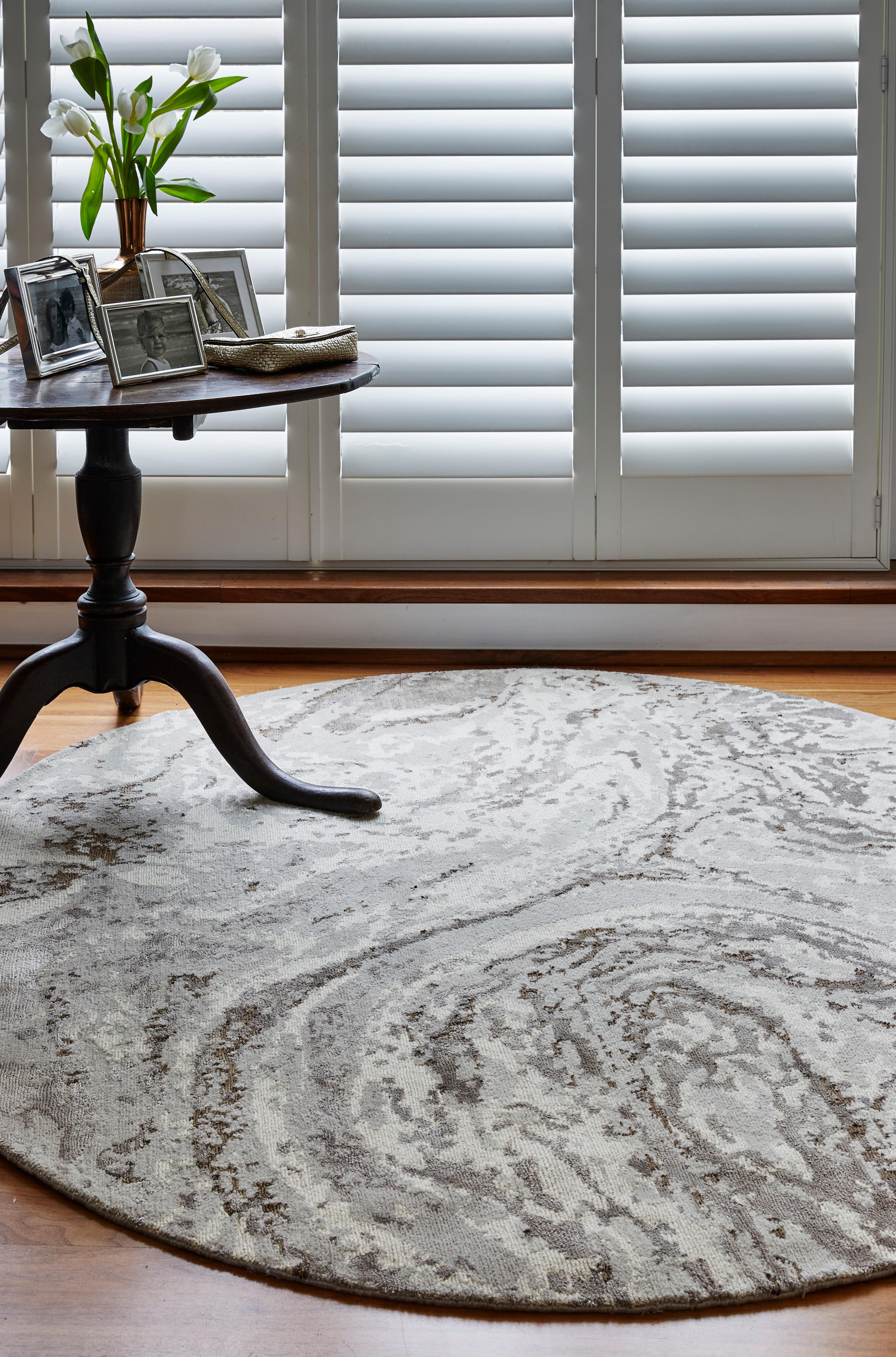 The fluid patterns found in the travertine stone have here been interpreted in soft Himalayan wool and lustrous bamboo silk. Rendered almost entirely in muted colours, the design is illuminated by metallic flecks of bronze and silver that are sure