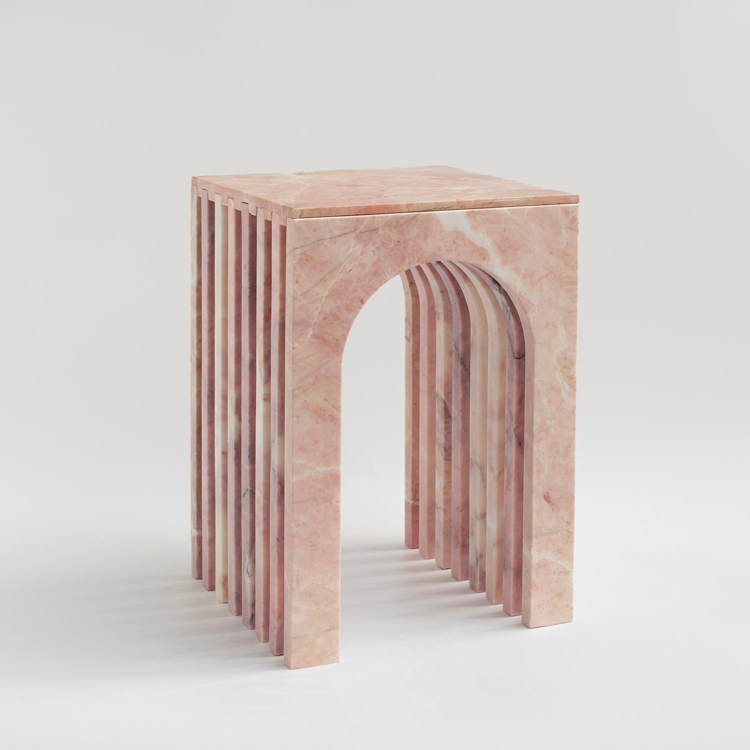 With a hint of feminine flair, this Pink Marble Side Table brings a subtle pop of color and charm to any room.
Crafted from gorgeous natural marble in a blushing pink hue, the arch-shaped silhouette consists of gracefully layered slabs that cascade
