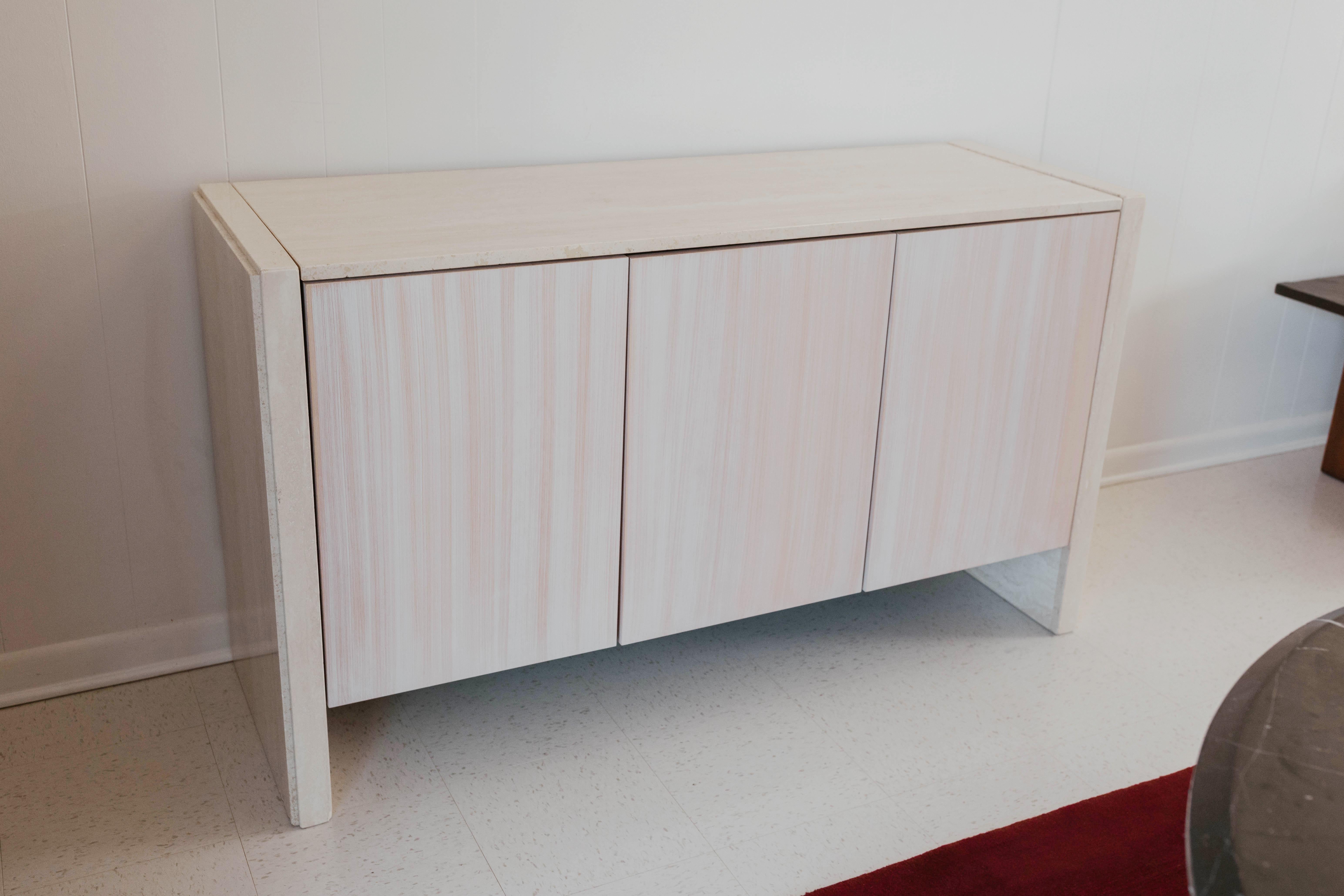 An incredibly stylish travertine sideboard credenza by Stone International S.p.A., this example is signed with its original Stone International label. 

With so few Travertine sideboards out there and with Travertine dining tables being such a hot