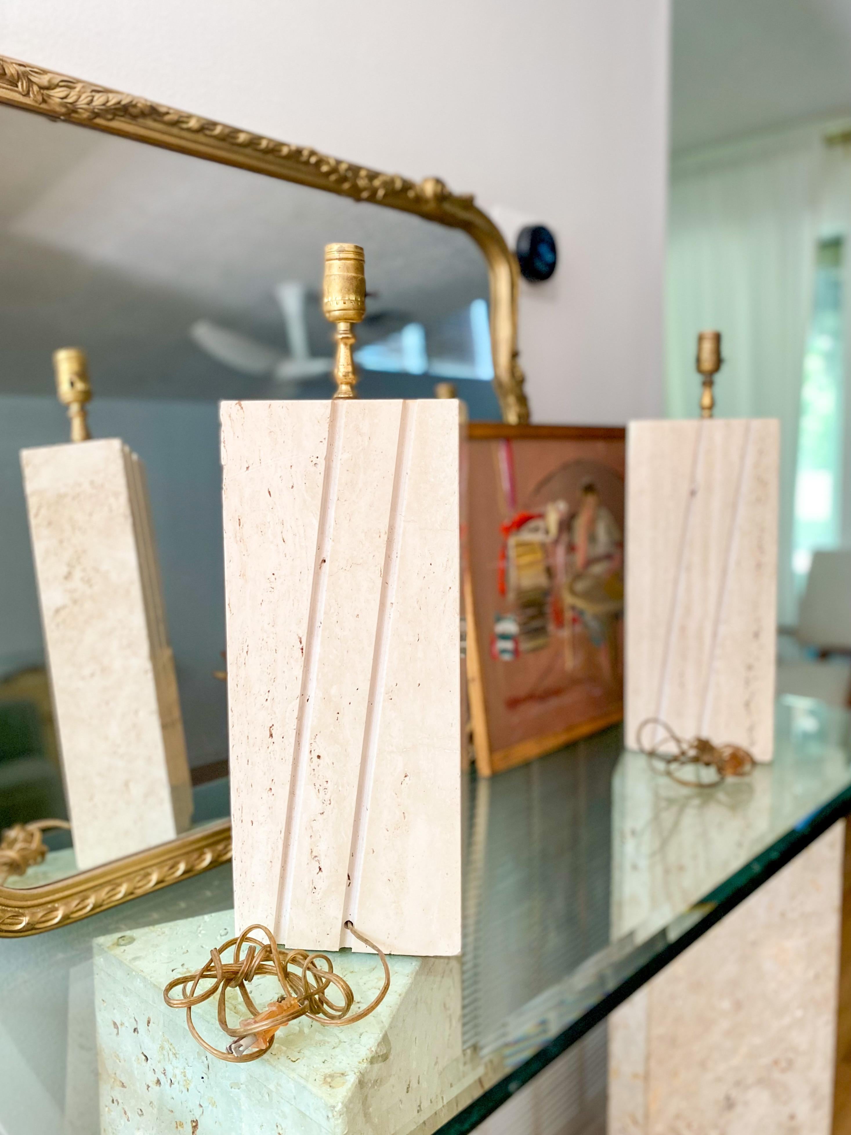 Gorgeous pair of Italian travertine table lamp bases in the style of Fratelli Mannelli, c.1970s. These substantial pieces are incredibly heavy. Natural, porous, travertine has plenty of natural texture which is beautifully juxtaposed with geometric