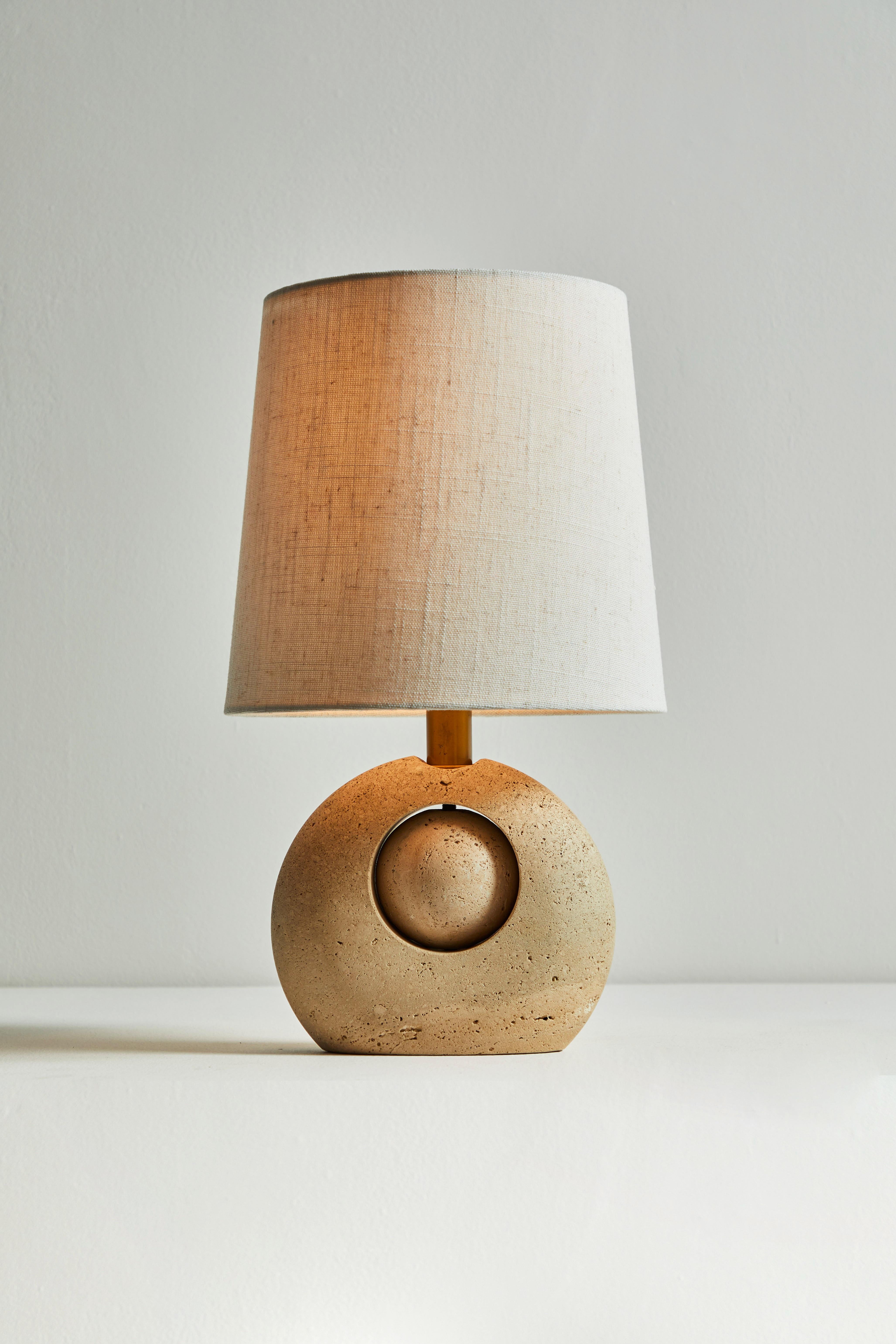 Travertine table lamp by Nucleo Sormani. Manufactured in Italy, circa 1960s. Travertine, brass stem, custom linen shade. Original European cord, comes with U.S. adaptor. We recommend one E27 40w maximum bulb. Bulb provided as a one time courtesy.