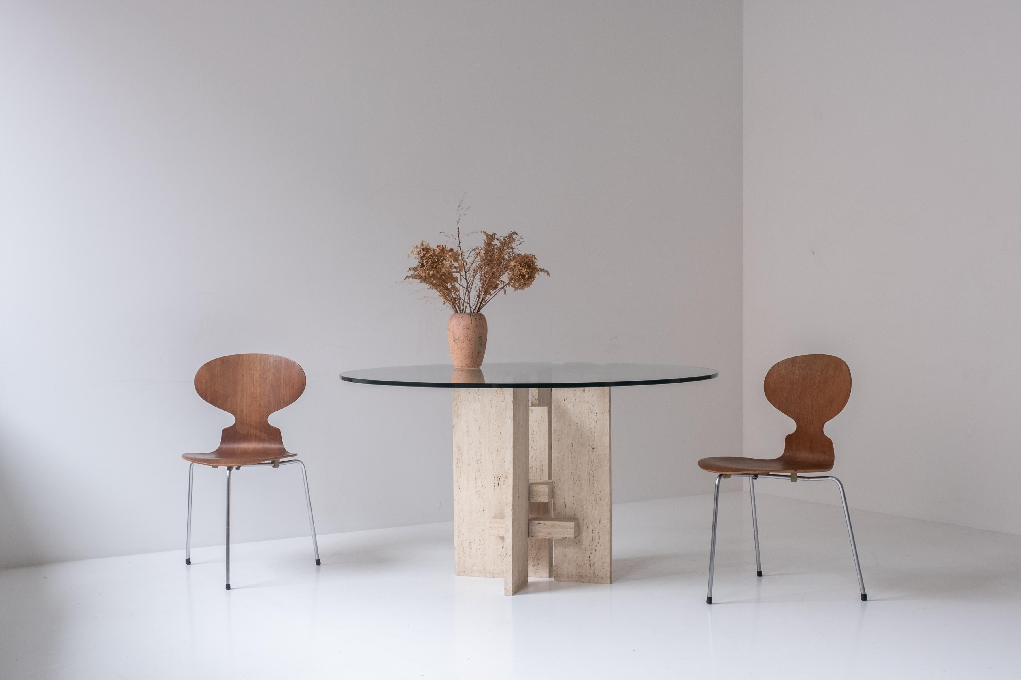 Glass Travertine table with sculptural base designed and manufactured in the 1970s. For Sale