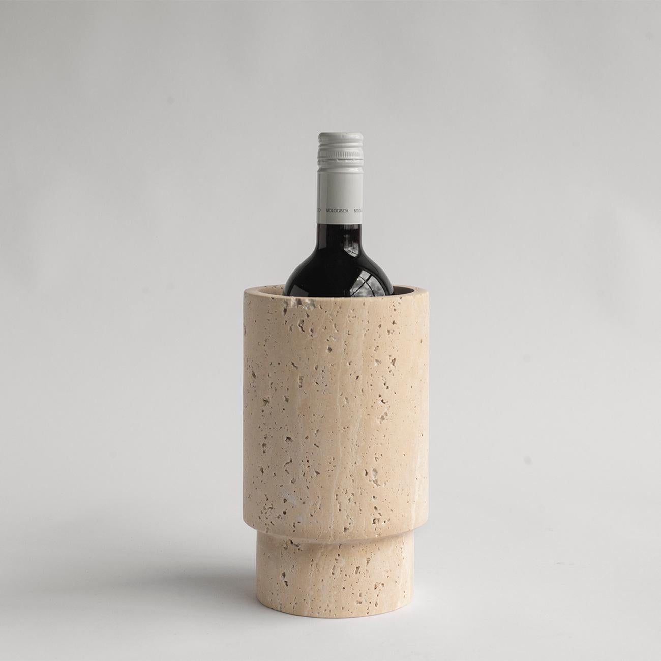 Our wine cooler is designed by us and hand crafted by the artisans within the fair-trade principles.

Crafted from a natural travertine stone, this vessel will be sure to win your heart. It can be used to hold your wine bottle, blooms, kitchen