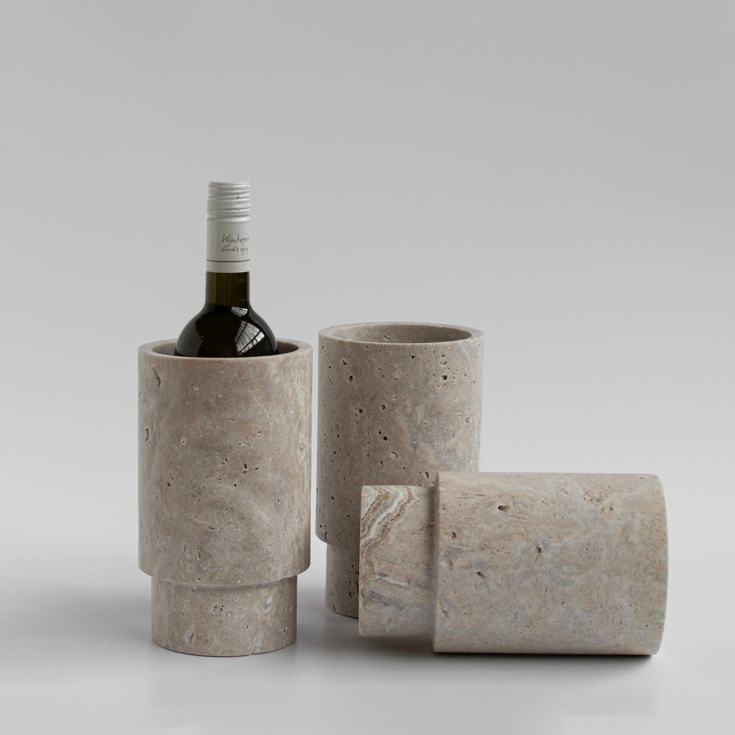 Our silver travertine vase is designed by us and hand crafted by the artisans within the fair-trade principles.

Crafted from a natural travertine stone, this vase will be sure to win your heart. It can be used to hold your wine bottle, blooms,