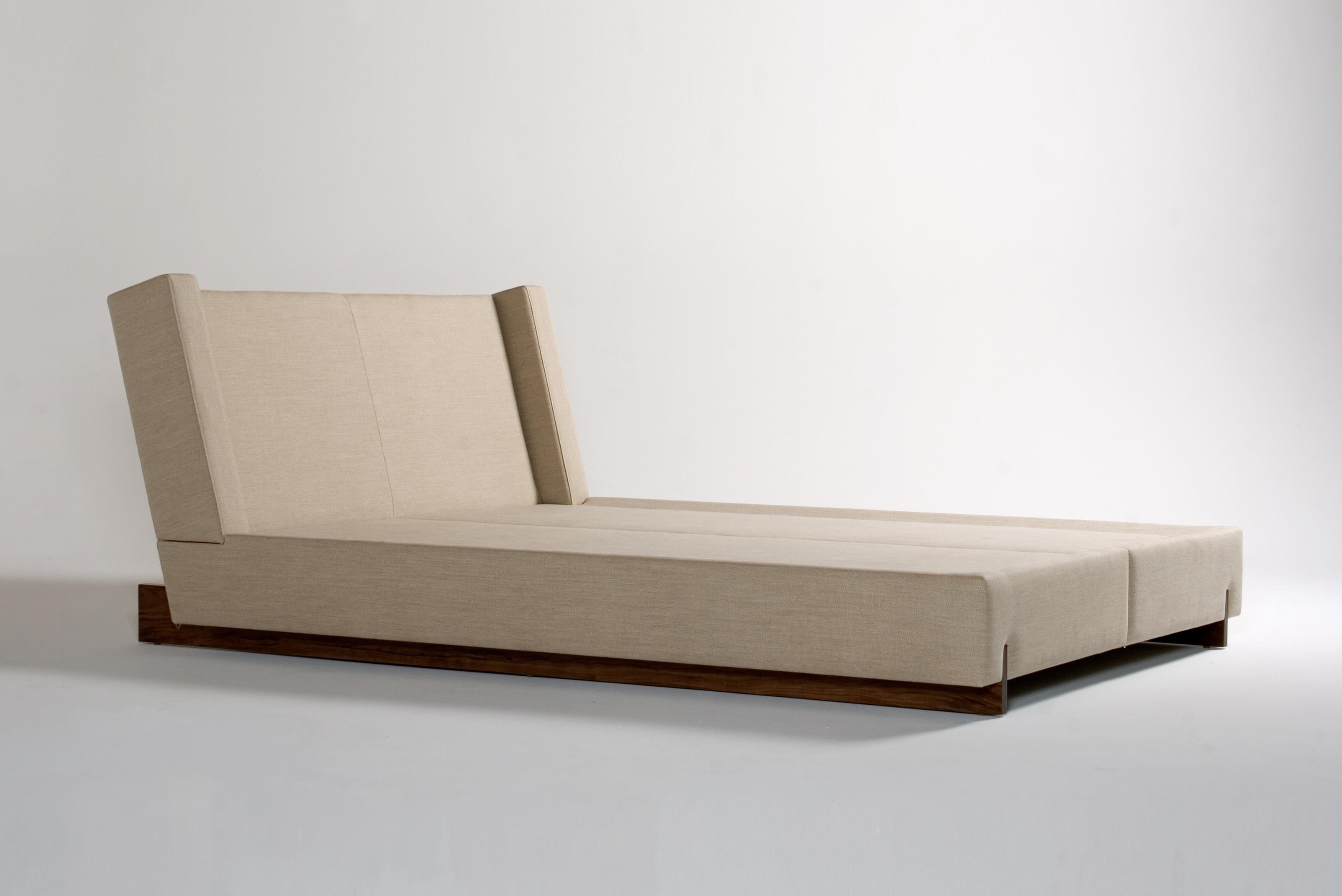 Trax Cali King Bed by Phase Design
Dimensions: D 242.6 x W 203.2 x H 94 cm. 
Materials: Walnut and upholstery.

Solid wood legs with upholstered body. Available in walnut, white oak, or ebonized oak. Upholstery may be sourced in Customer Own