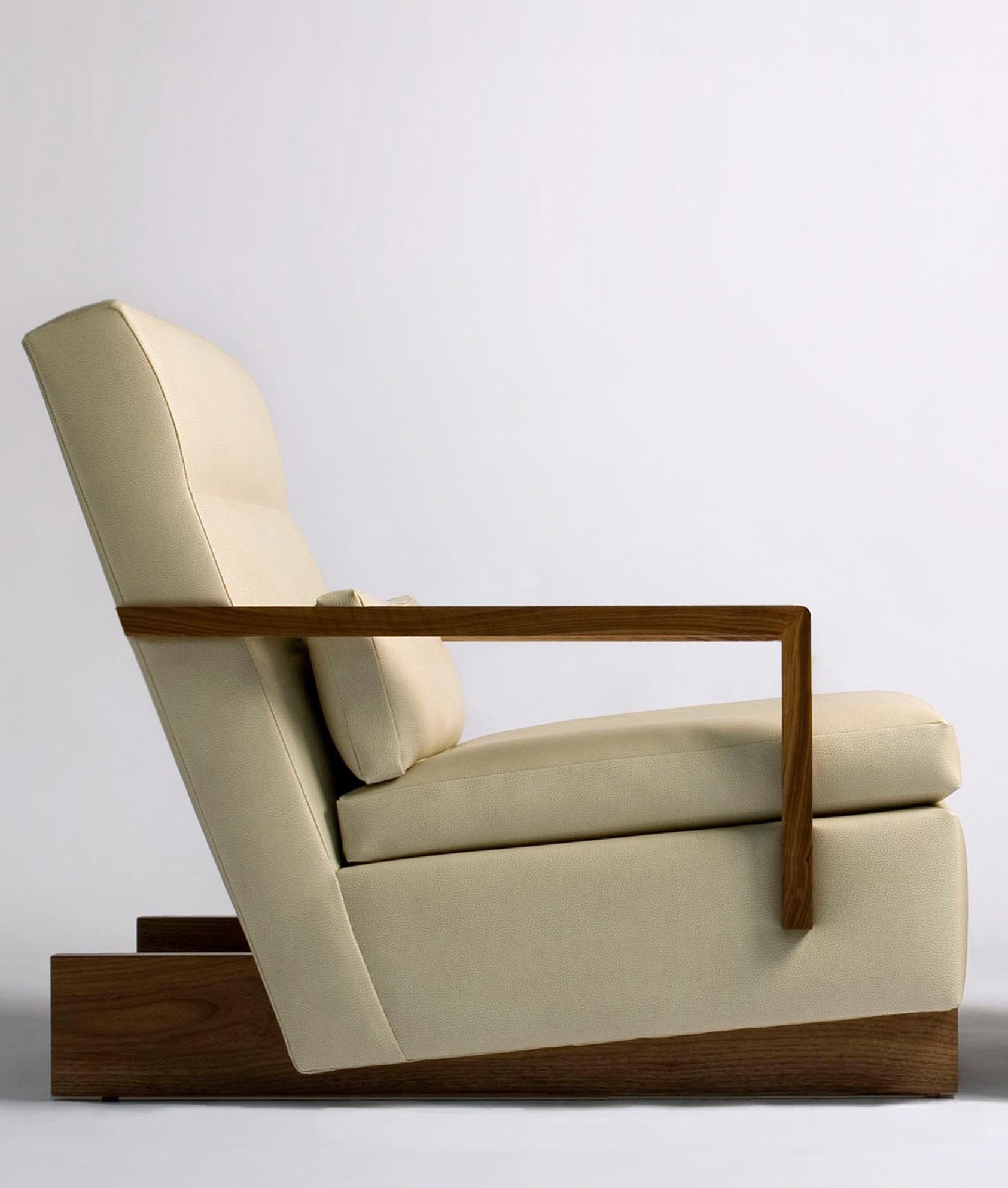 Trax Lounge Chair With Arms by Phase Design
Dimensions: D 97.8 x W 72.4 x H 84.5 cm. 
Materials: Walnut and leather.

Solid wood legs and armrests with upholstered body, available in walnut, white oak, or ebonized oak. Available with or without