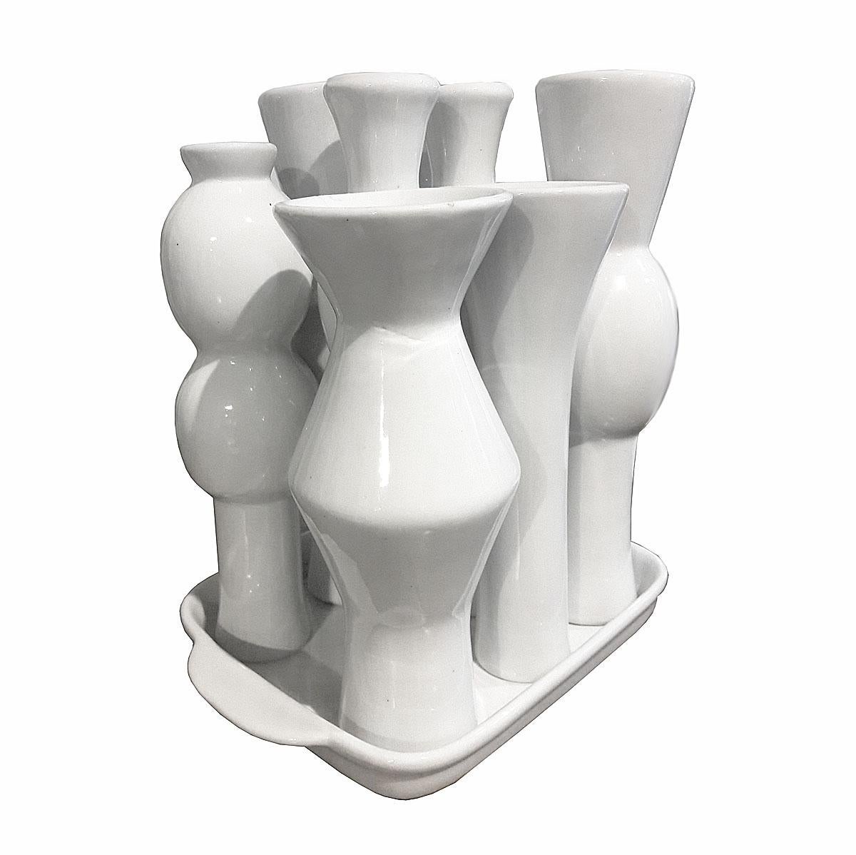 A handmade white porcelain sculpture of eight vases in different shapes and sizes resting on a tray. Contemporary design. From Netherlands, early 2000s.