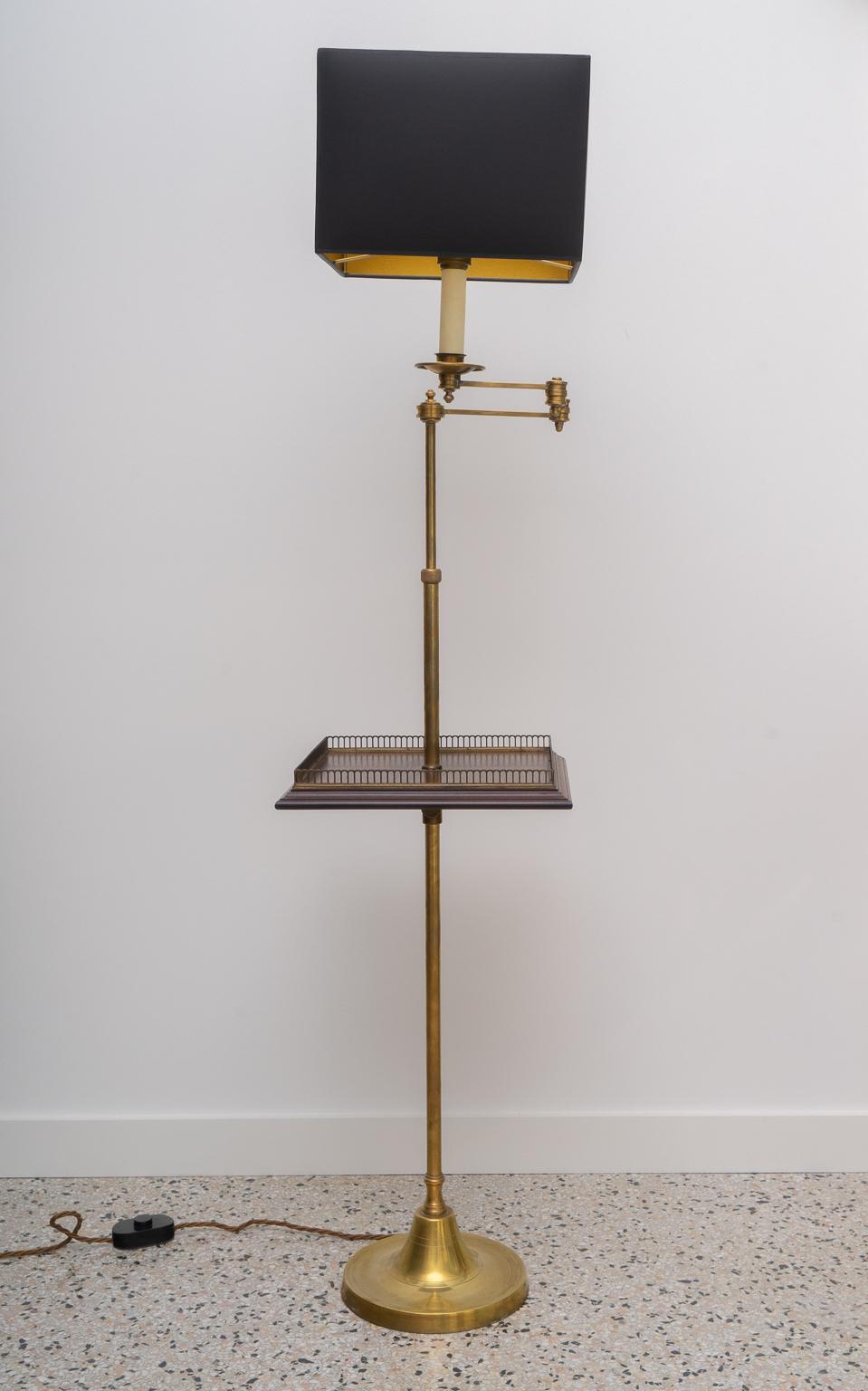 This stylish and Classic floor lamp was created by Vaughan design and dates to the 1990s. The antique brass, mahogany woods and paper shade all work beautifully together. The adjustable arm works with ease to give you that perfect positioning of the