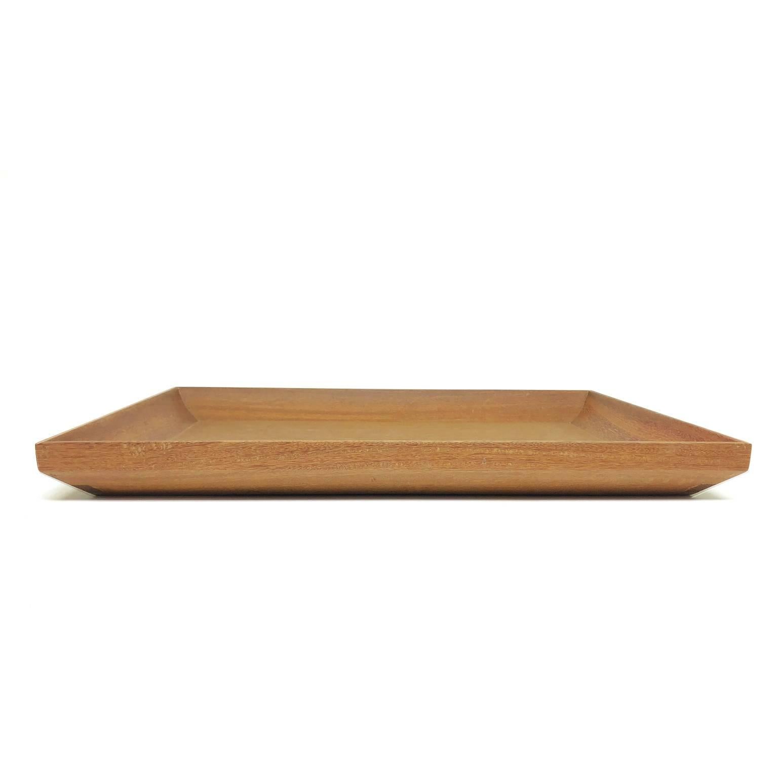 The frame of tray is made in Brazilian solid wood Cumaru with traditional handcraft joint techniques. The base is veneered with natural wood. Finishing in Italian acrylic matte varnish that shows the beauty of wood.