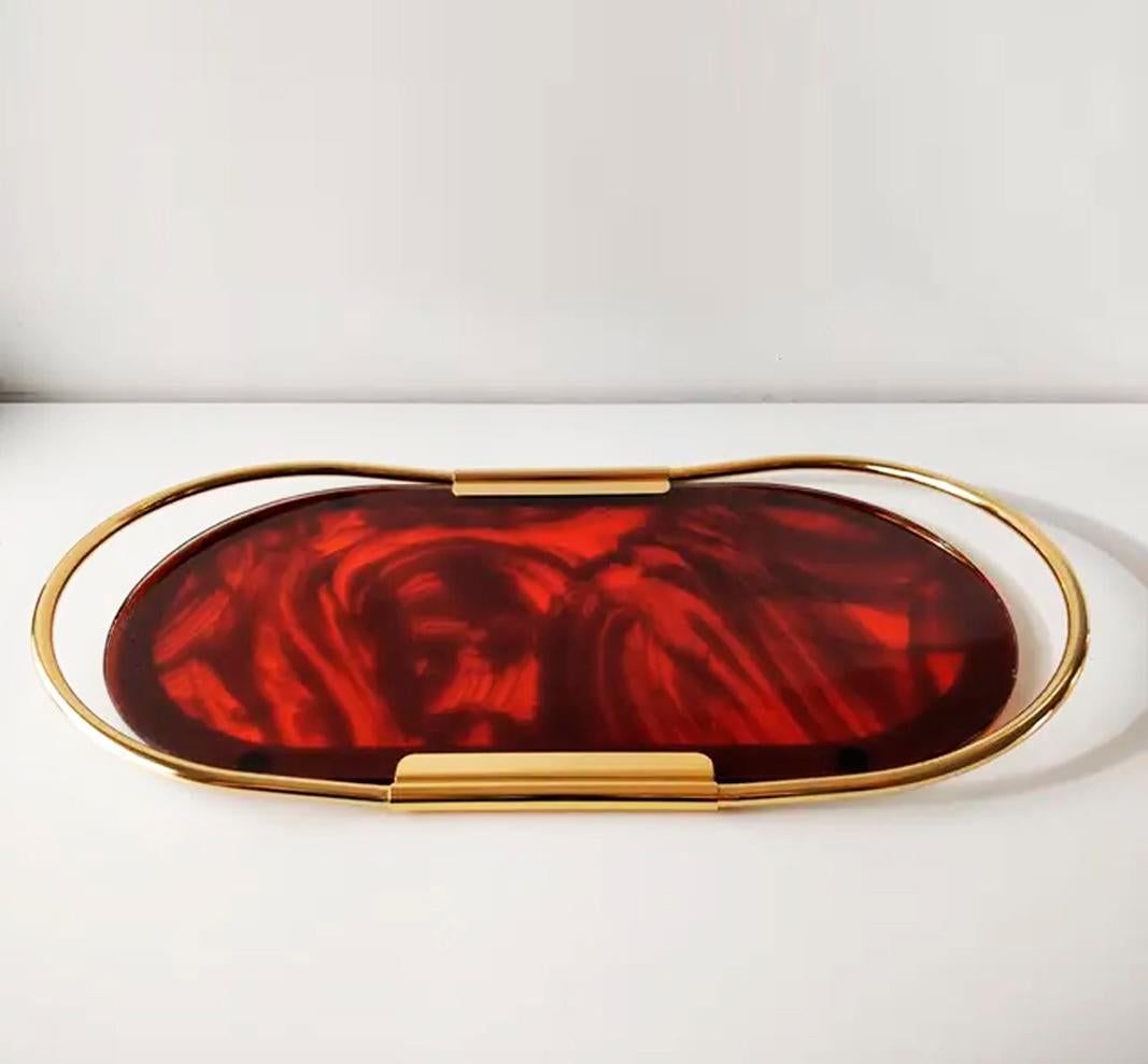         * request a shipping quote
Vintage Italian Mascagni Lcucite tray
Lucite tray (acrylic or plexiglas) with tortoise shell design and gold metal edge. It is oval in shape and has two handles to hold it

53×29 cm tray of the Mascagni brand, made