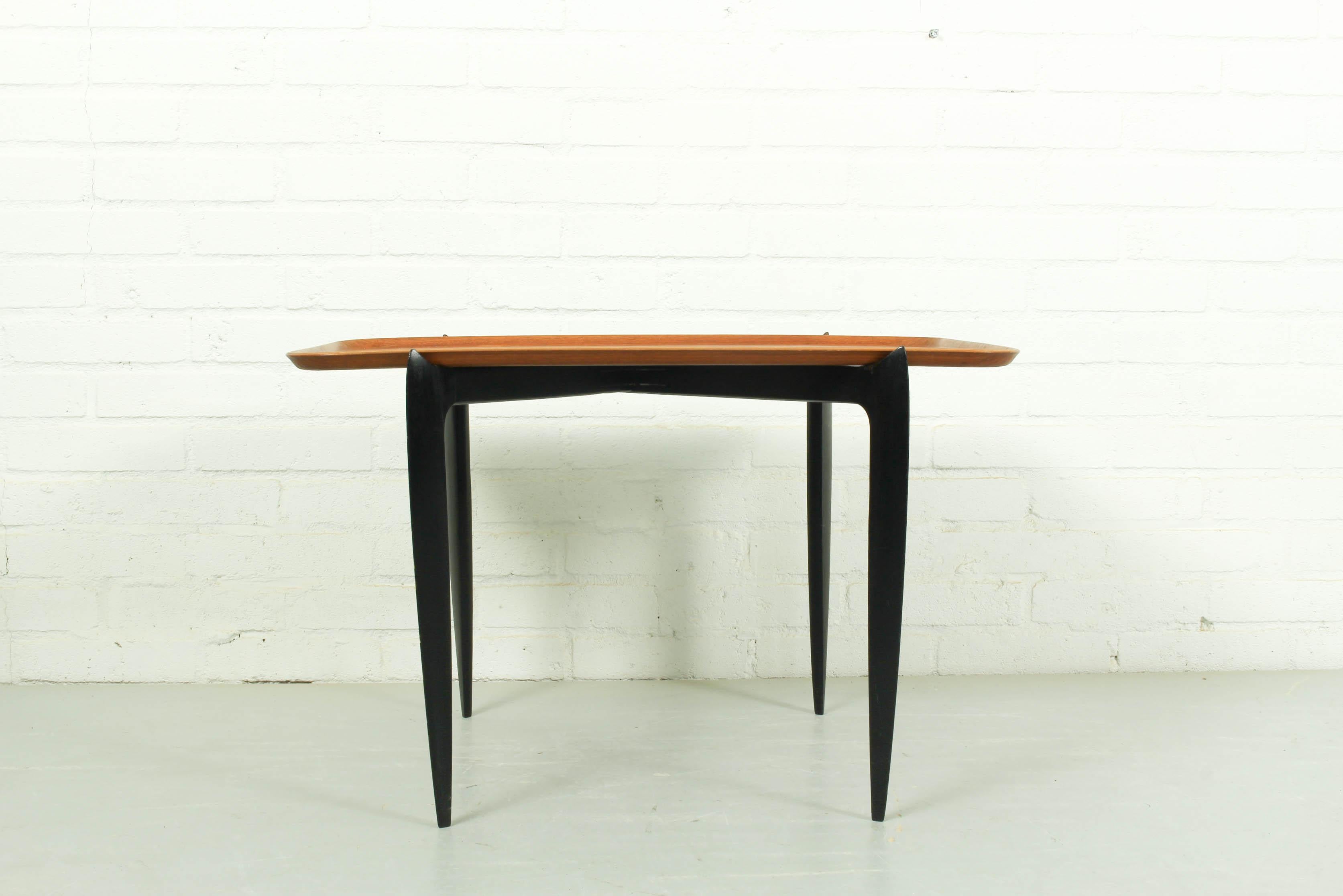 Rectangle tray side table designed by Svend Åge Willumsen & Hans Engholm for Fritz Hansen, Denmark 1950. It has a teak tray top, black wooden base with a folding mechanism. The table is an early version and made in very limited numbers. It’s marked