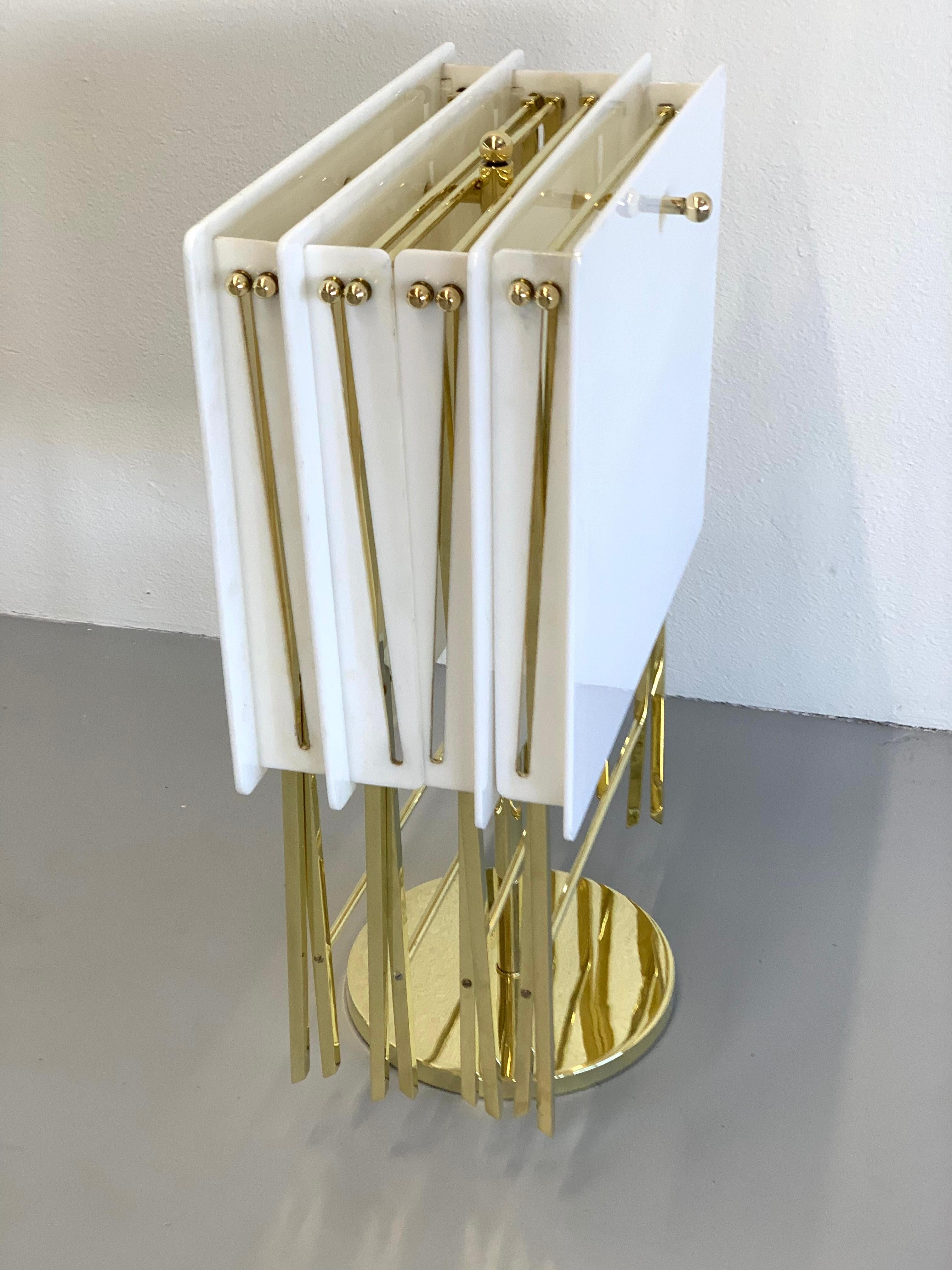 A nice early set of white acrylic and brass folding tables with a matching stand to hold them from when not in use. This group to the 1960s as Charles Hollis Jones recently pointed out when he authenticated them as his work on a recent visit to the