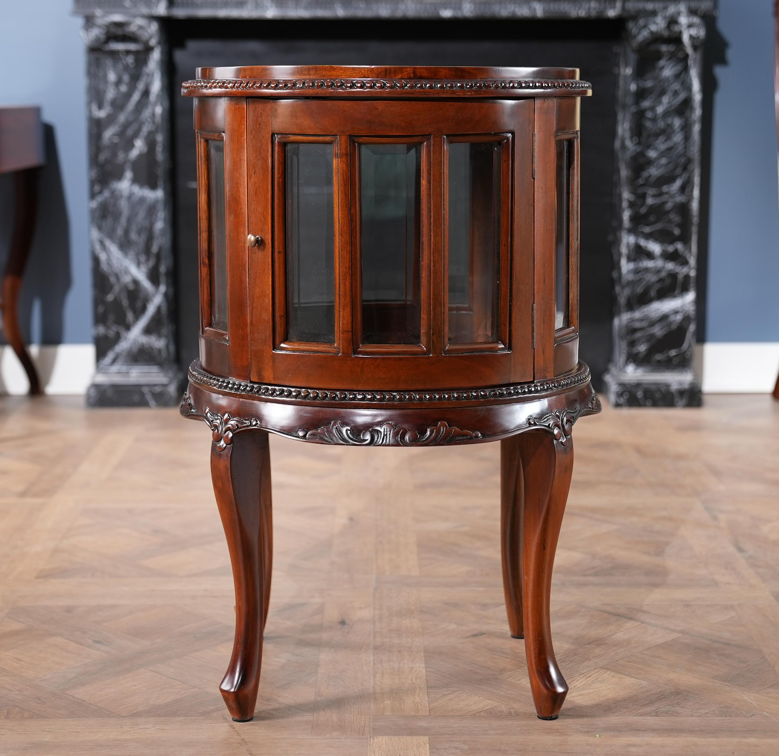 The Round Tray Top Mahogany Display Table from Niagara Furniture is an exercise in elegance. The sweeping  mahogany legs are created by hand and support the table’s finely carved skirt and glassed in display area which itself feature individual