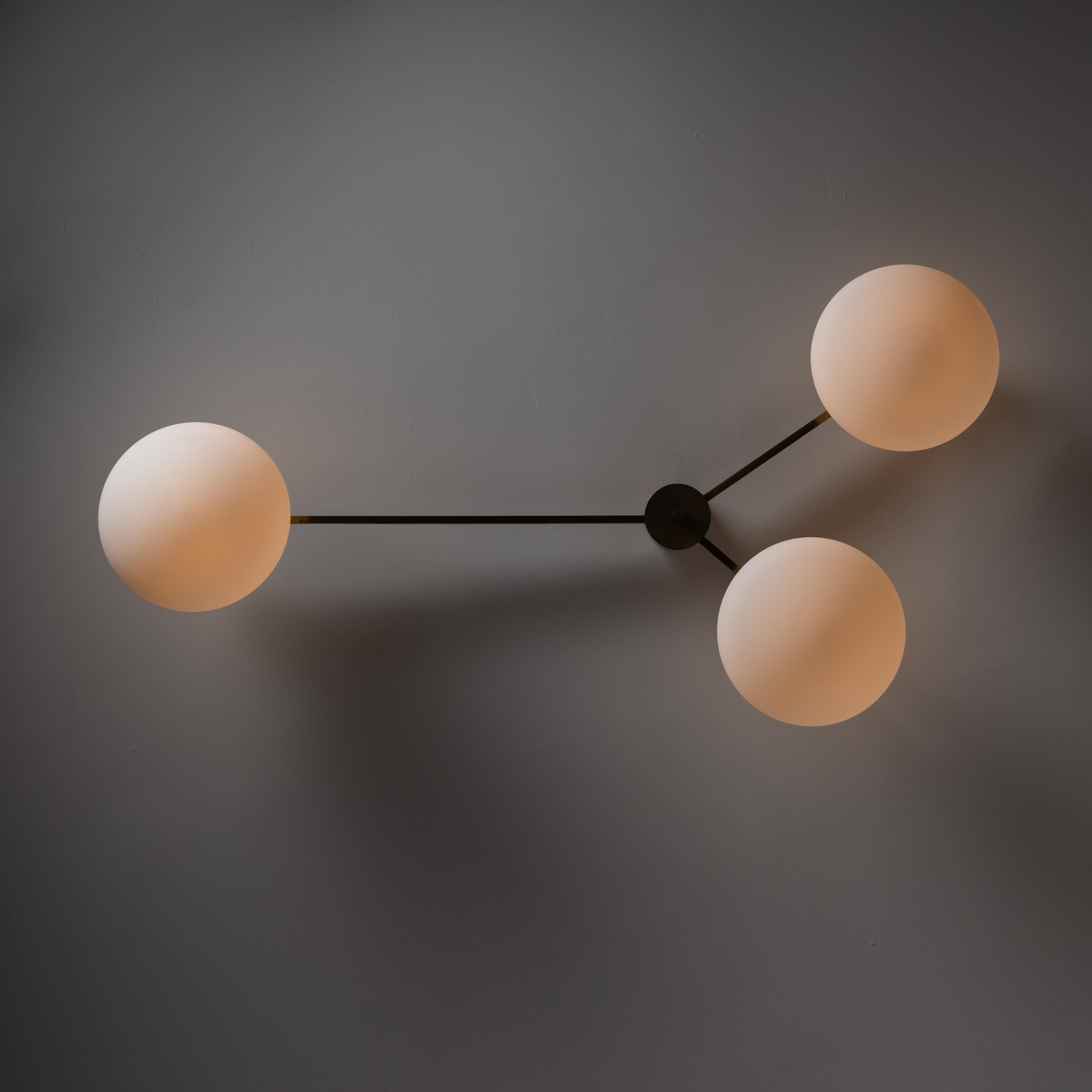 Three Lune Chandelier by Angelo Lelli for Arredoluce. Designed and manufactured in Italy, circa 1970. Timeless flush mounted chandelier with aged brass armatures and three opaline glass oval diffusers. This gorgeous flush mount chandelier that can