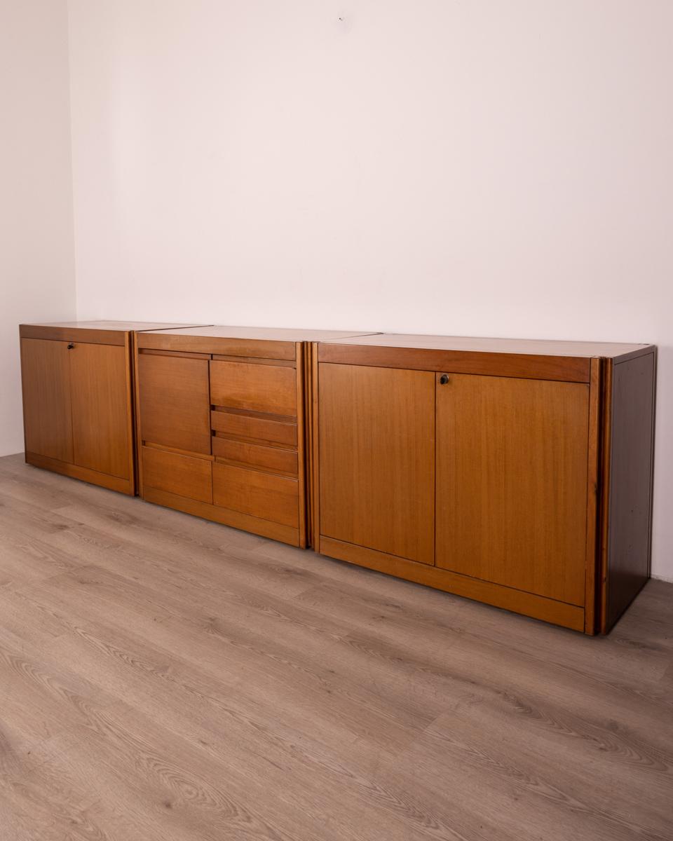 Three modular sideboard cabinets made of Walnut wood and equipped with wheels, model 4D, design Angelo Mangiarotti for Molteni, 1960s.

CONDITION:
In good, working condition, showing signs of wear given by time.

SIZING:
The dimensions relate to the