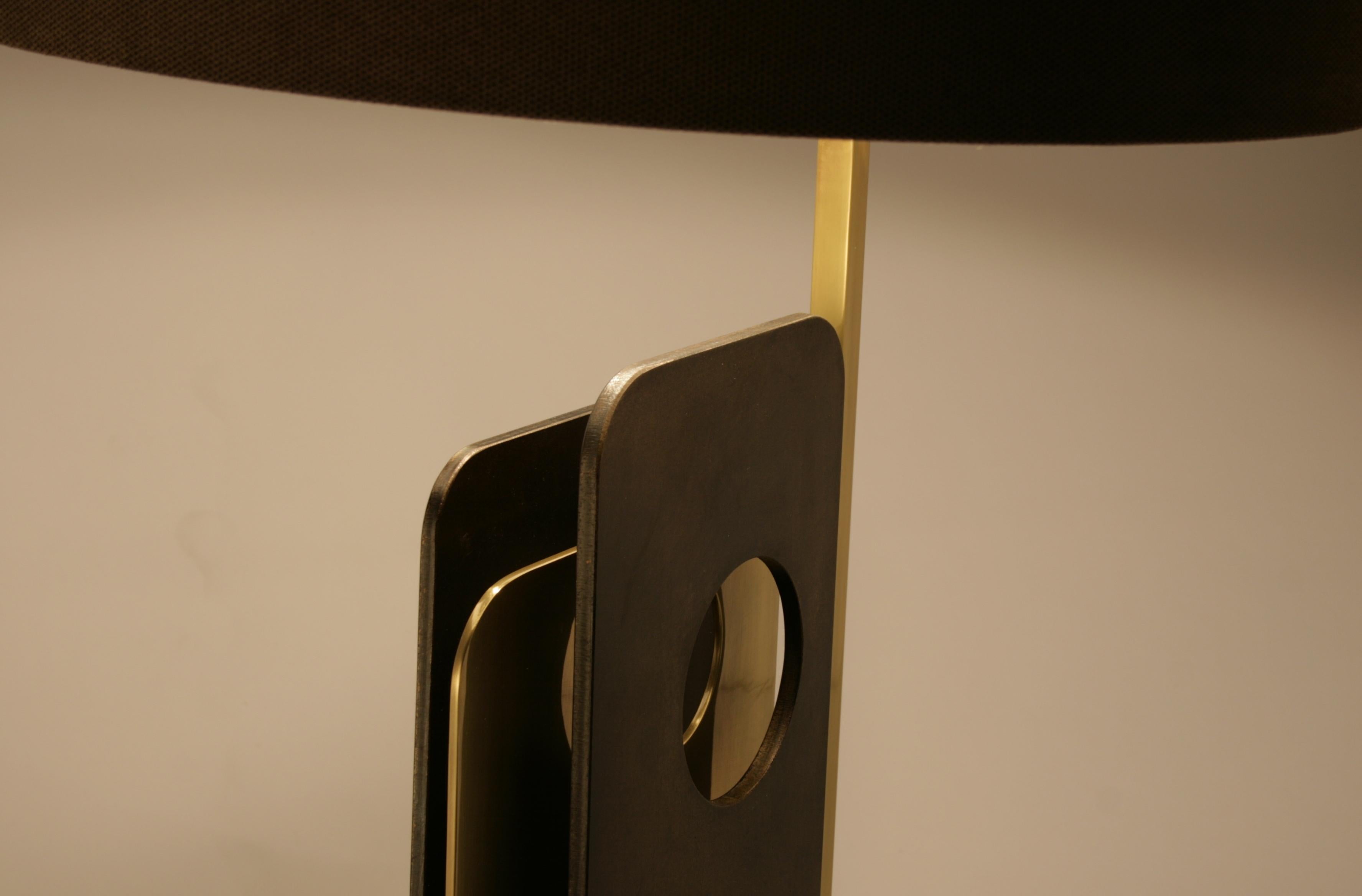 Table lamp in brass and iron with travertine base.