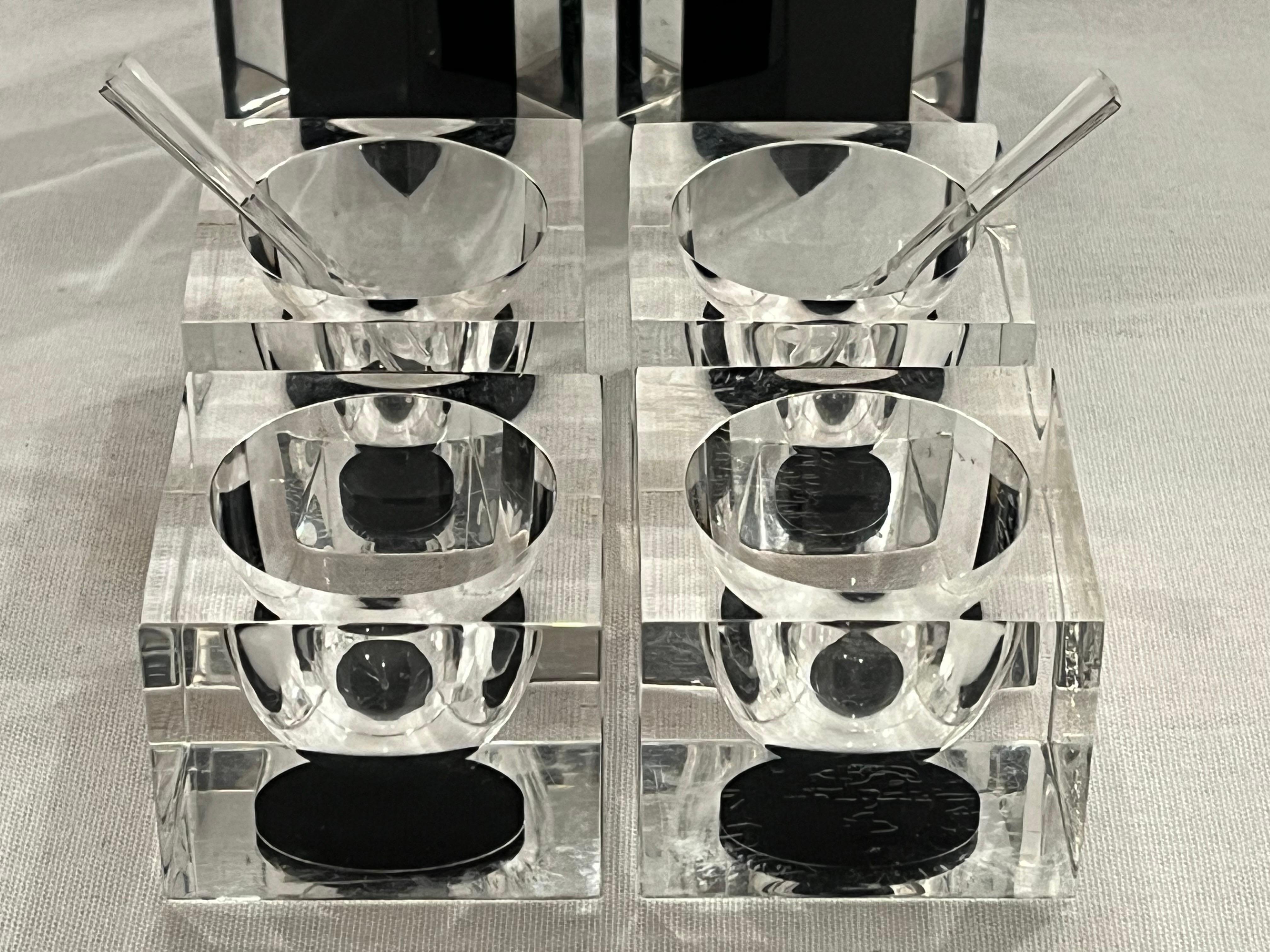 A vintage, circa 1970's  (maybe 1980's) set of clear and black acrylic of two pepper grinders, four salt holders and two spoons. If you're having a dinner party and want to impress your guests, then this set will help you achieve just that (not that