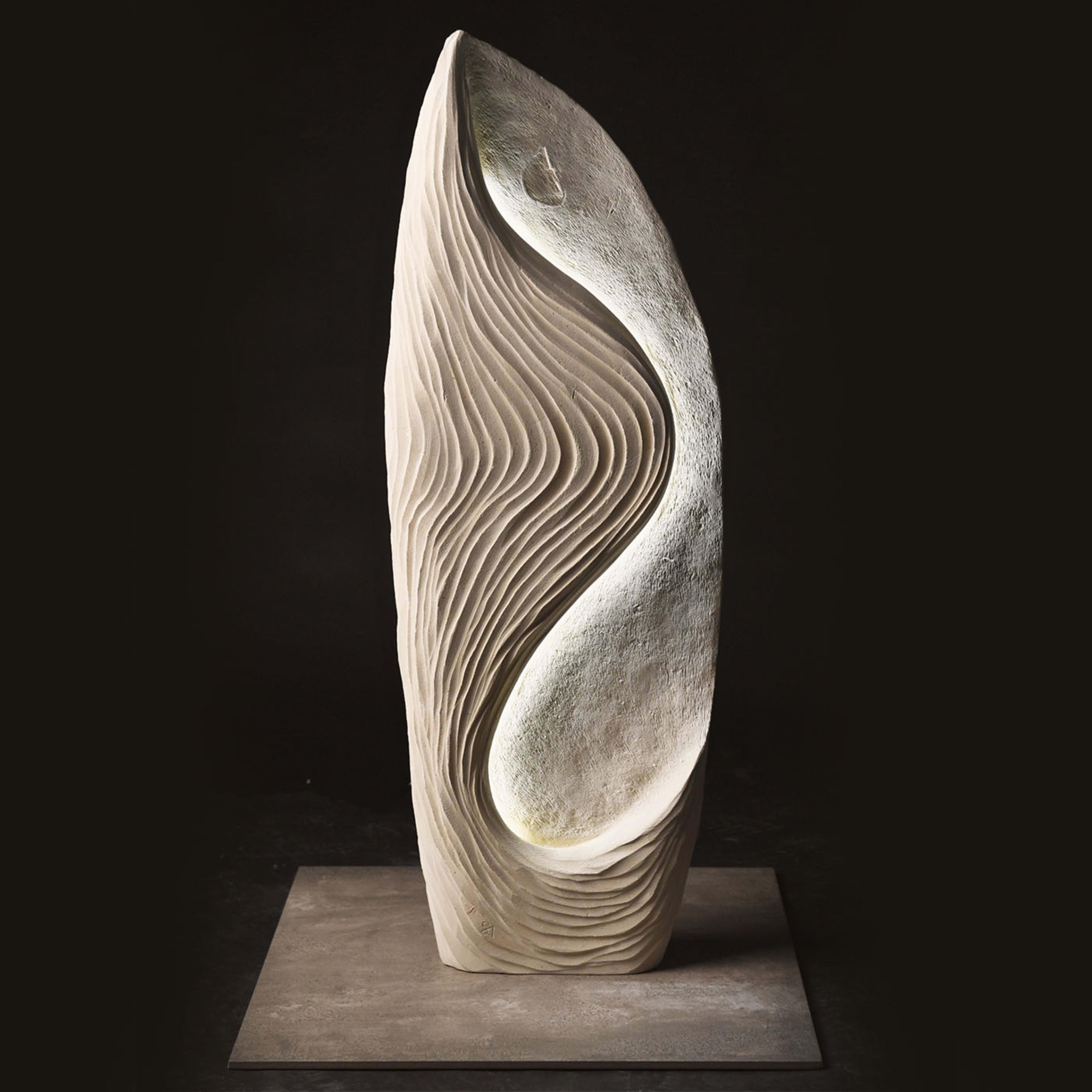 This one-of-a-kind sculpture by artist Andrea Serra is handcrafted of a special marine-origin white stone rich in fossils. Only quarriable near Lecce, Apulia, this stone here employed is enriched with a warm white LED strip whose glow gets seemingly