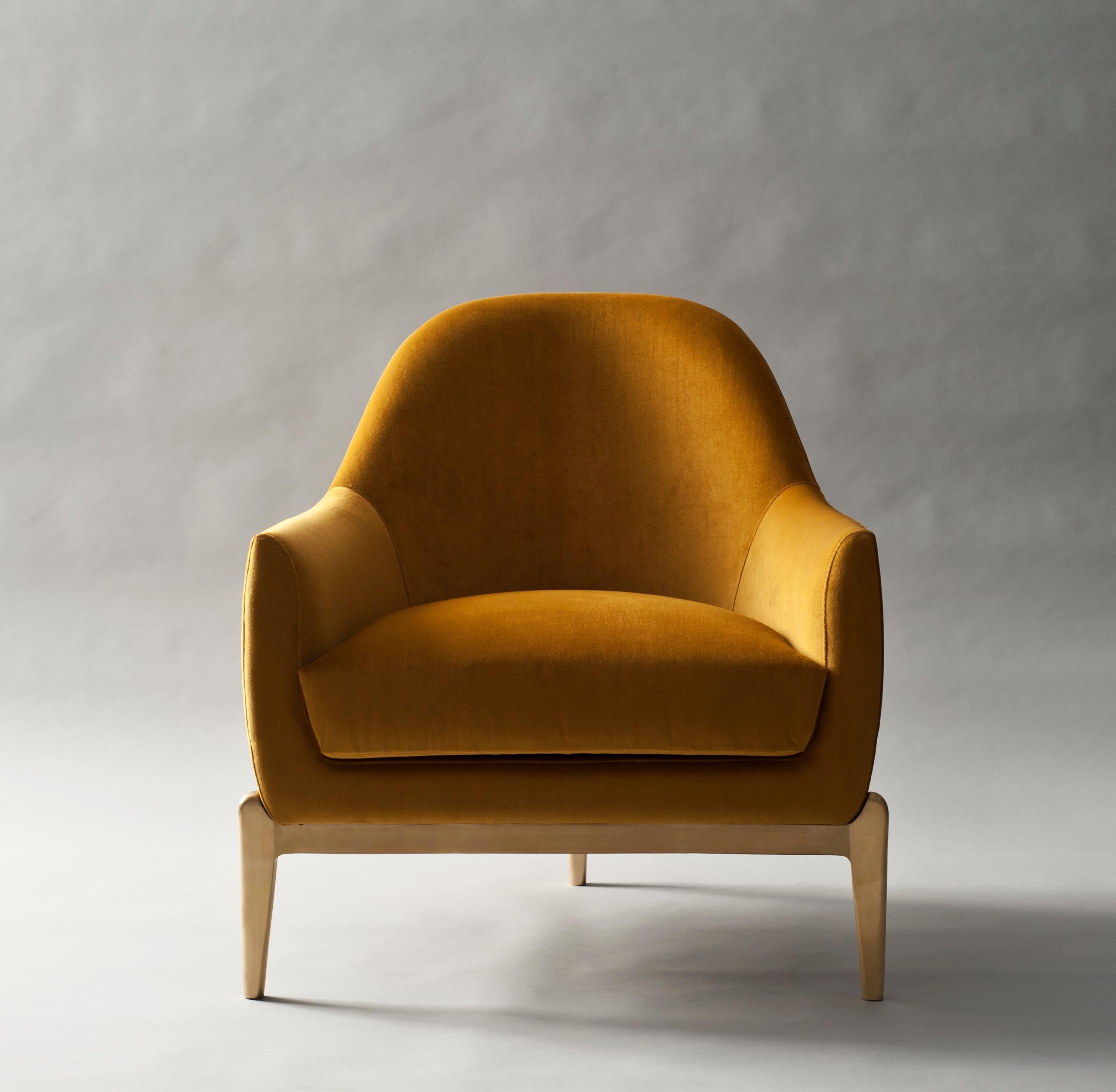 The Treble side or armchair by DeMuro Das has a curved profile supported by a hand-cast, three-legged base in solid satin bronze. A solid hardwood frame with European webbing and multi-density foam gives this piece solidity and strength. The chair