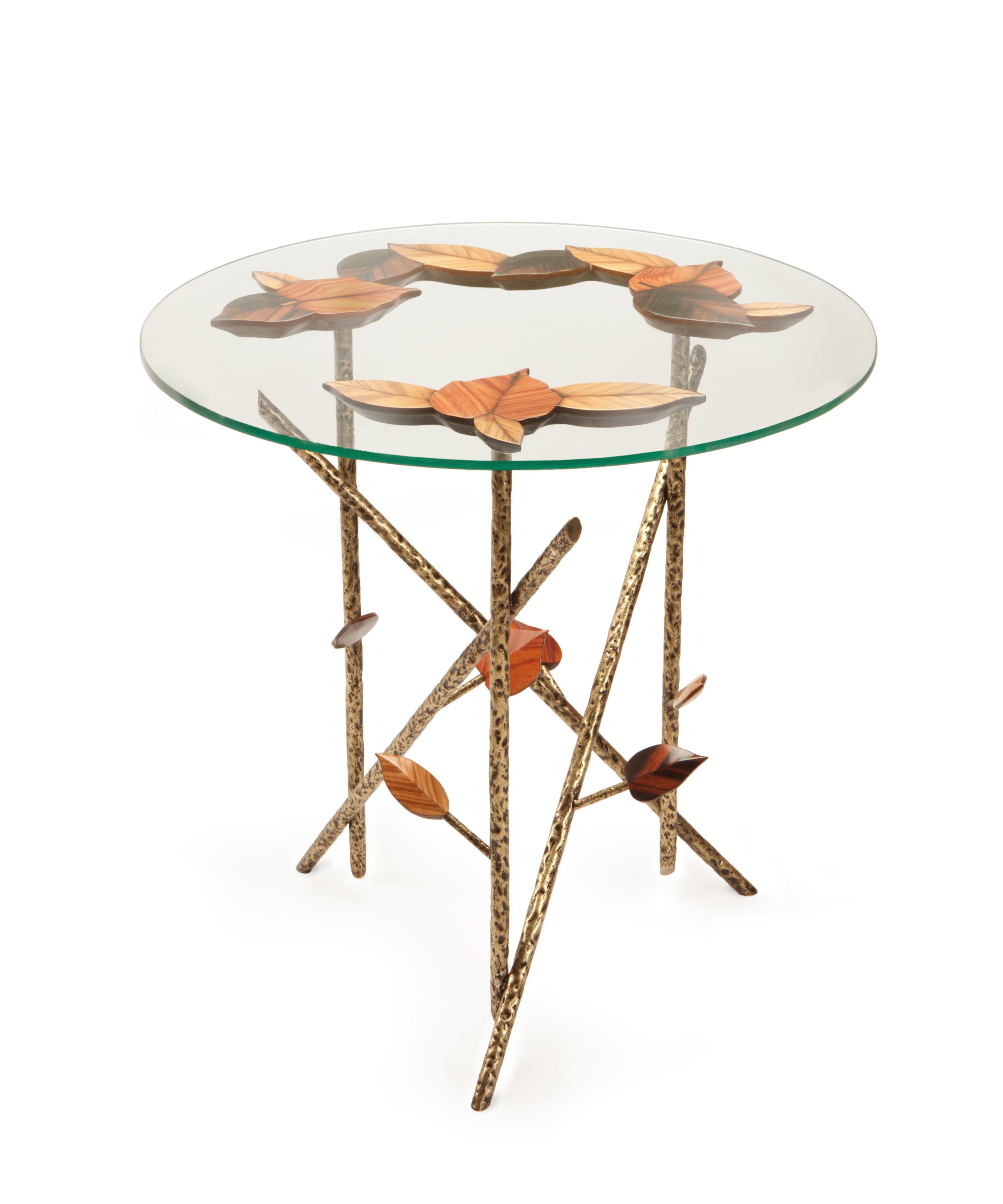 Inspired by the trees that in Autumn hold their foliage with difficulty, Tree Branches transmits the nakedness of the season.

Entirely handcrafted using traditional techniques like marquetry and hammered metal, Tree Branches is an extremely