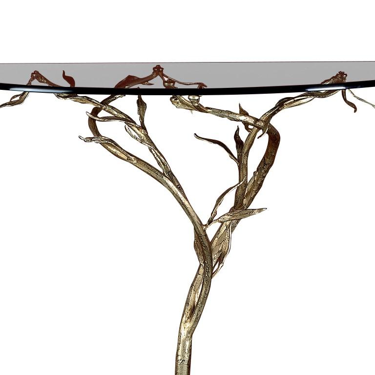 Boasting masterful craftsmanship, this console will make a striking first impression in a Classic decor. The base is crafted of hand-forged iron in the shape of a tree, resting its curved roots on a round base and stemming out, spreading its