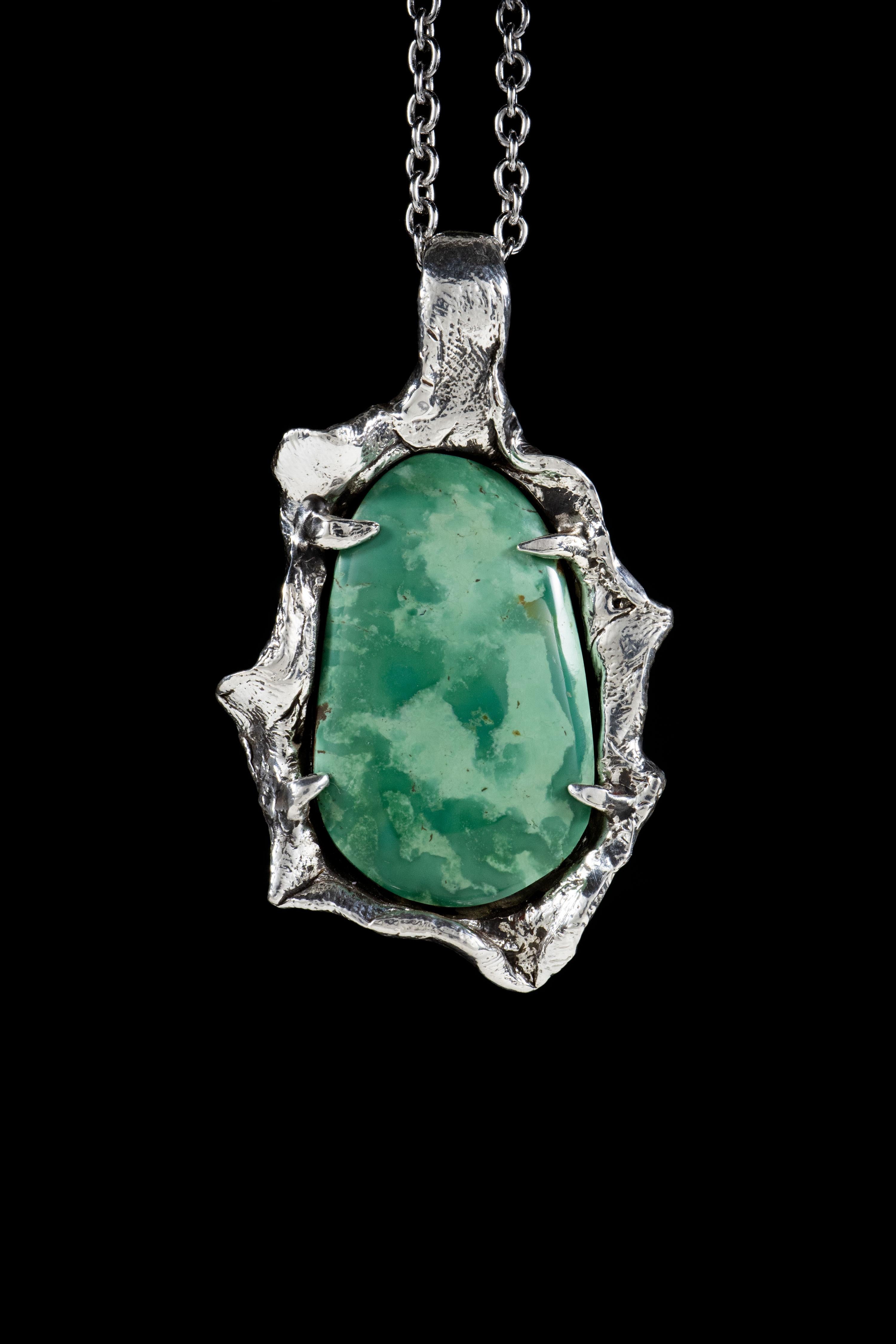 Tree Spirit is a stunning pendant handcrafted by Ken Fury in sterling silver, featuring a beautiful Manassa Turquoise stone. The pendant's intricate design symbolizes the interconnectedness of all living things and the importance of staying grounded