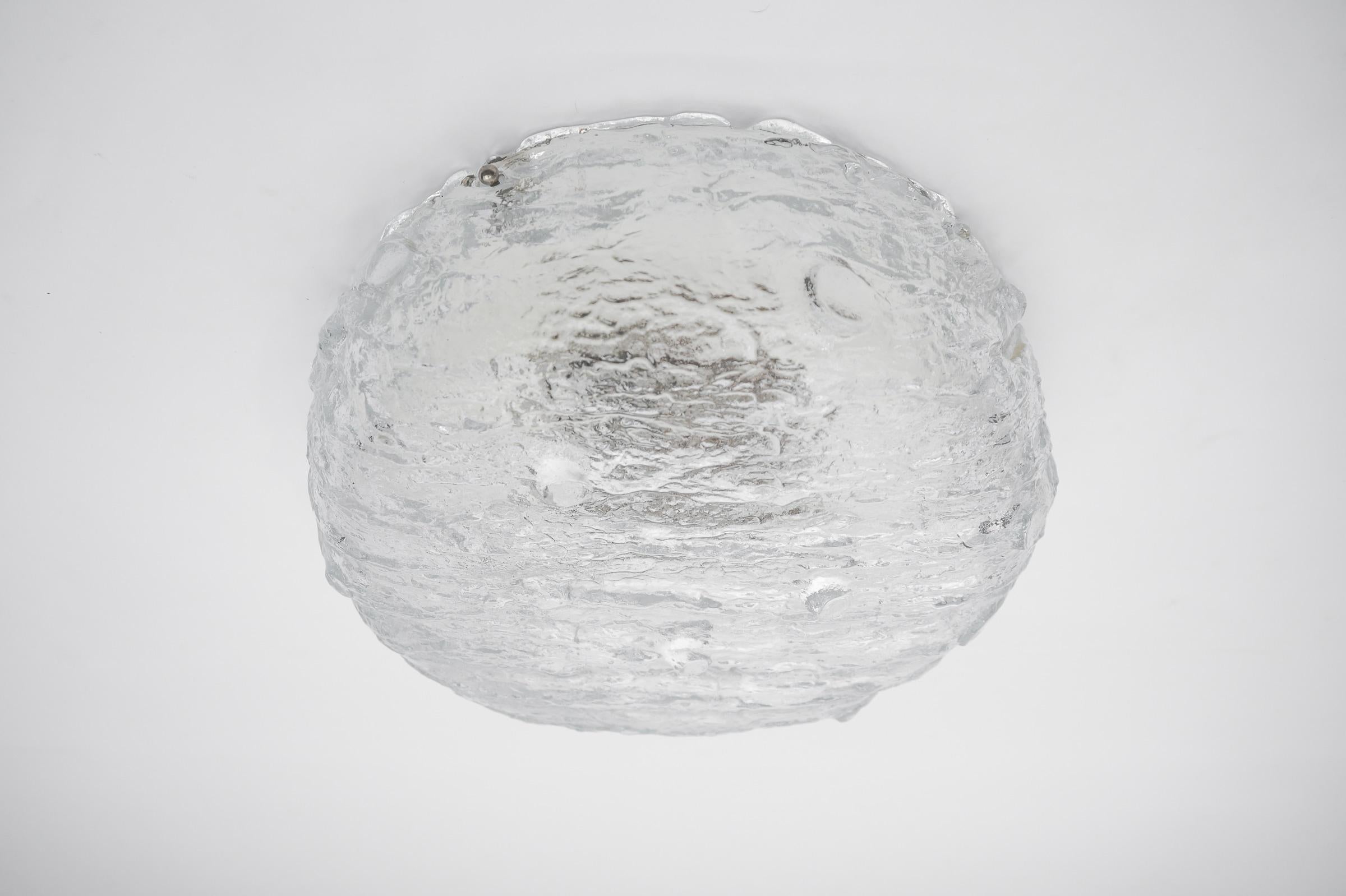 Tree Trunk Ice Glass Flush Mount by Kalmar Franken KG, Germany 1960s

This large flush mount was produced in Austria by Kalmar in the 1960s. It is composed of 12 thick textured ice glass elements attached to a white frame and uses four E27