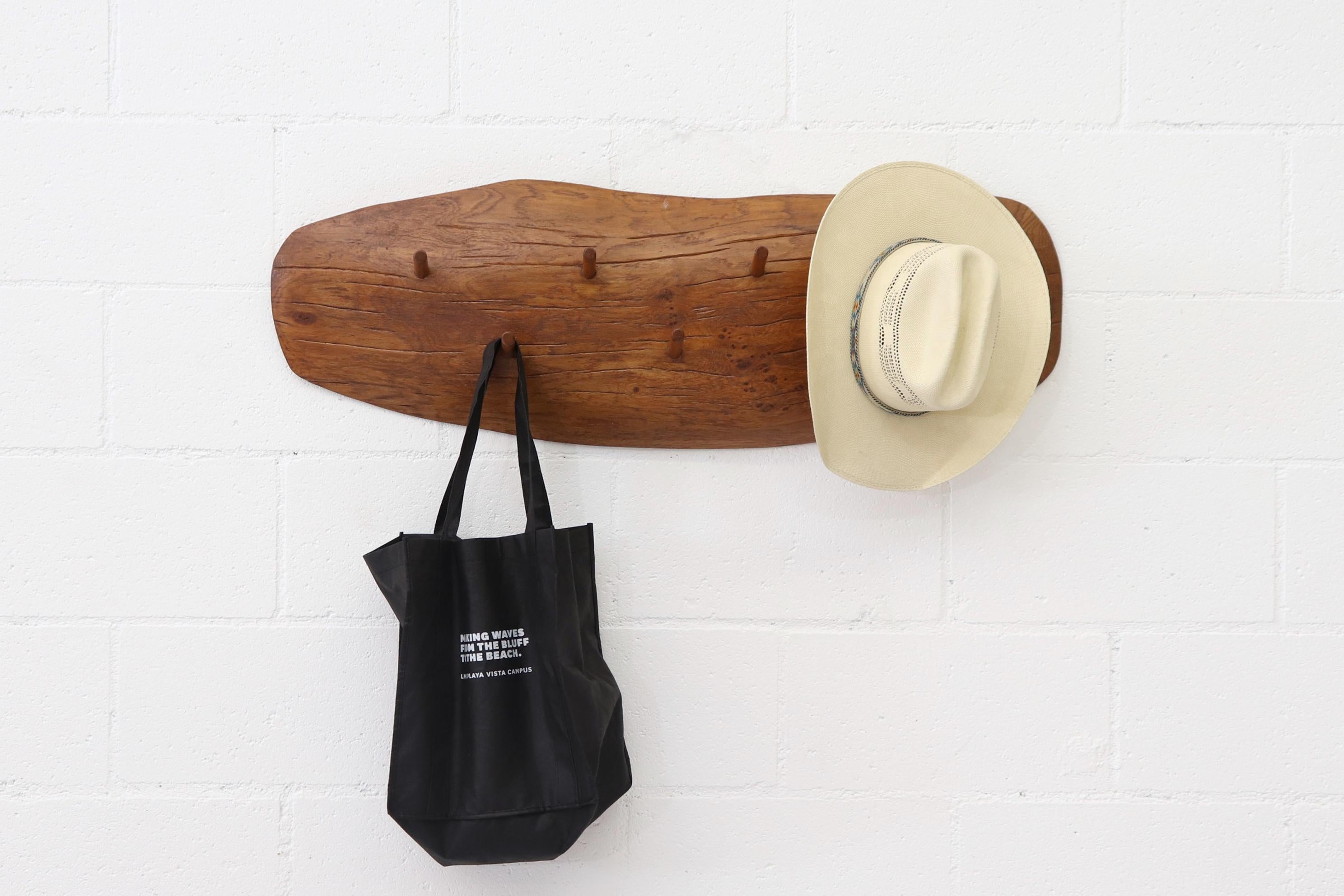 Brutalist wall-mounted natural wood coat or hat rack with 7 organically carved wood hooks. Space efficient with Rugged design and Rustic style. In original condition with minimal wear consistent with age.