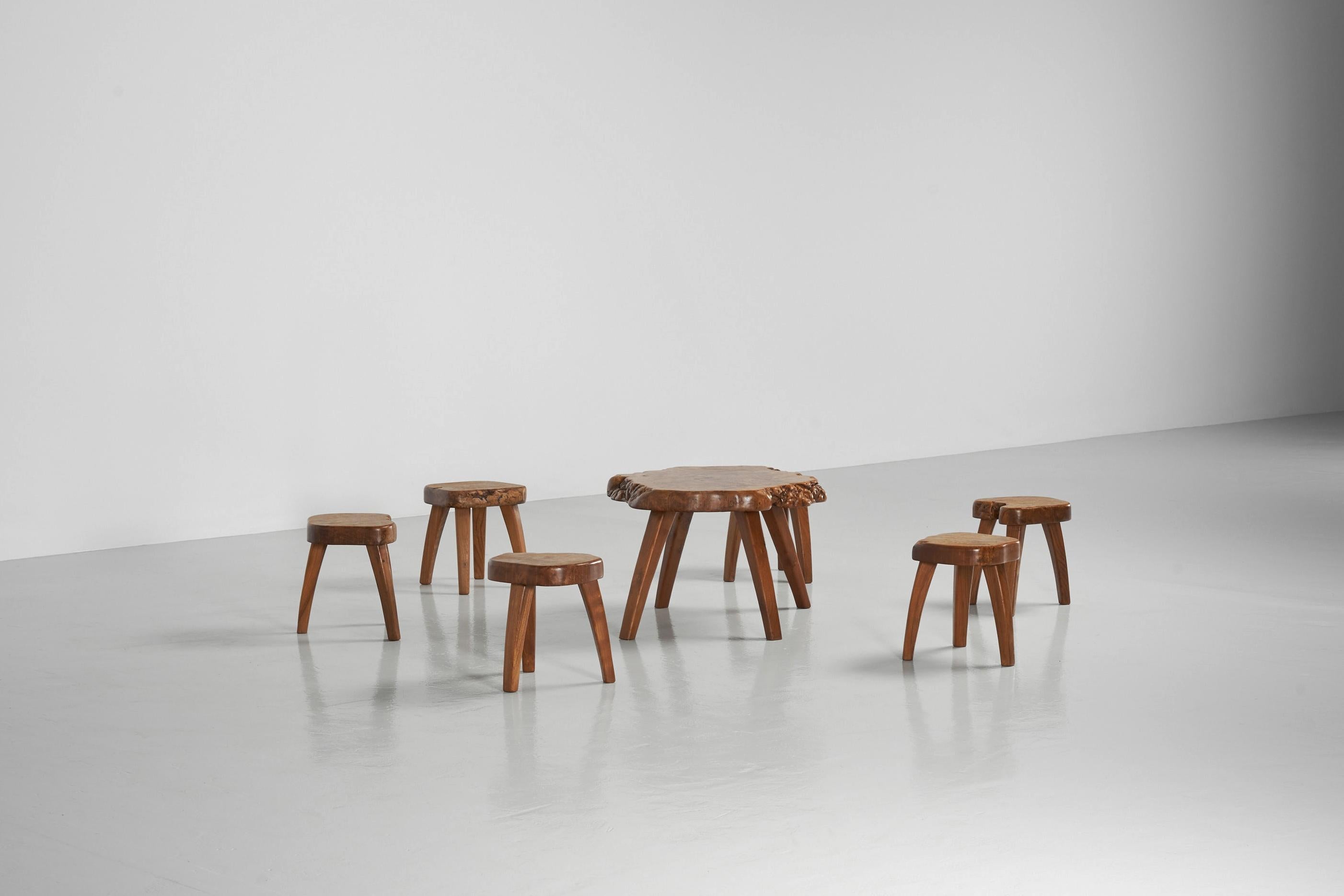 Playful seating group made by an unknown artisan in France, 1960s. This beautiful handcrafted set consists of 6 stools and a small coffee table. A very nice and sculptural set made in solid French elm. French elm is known for its beautiful orange