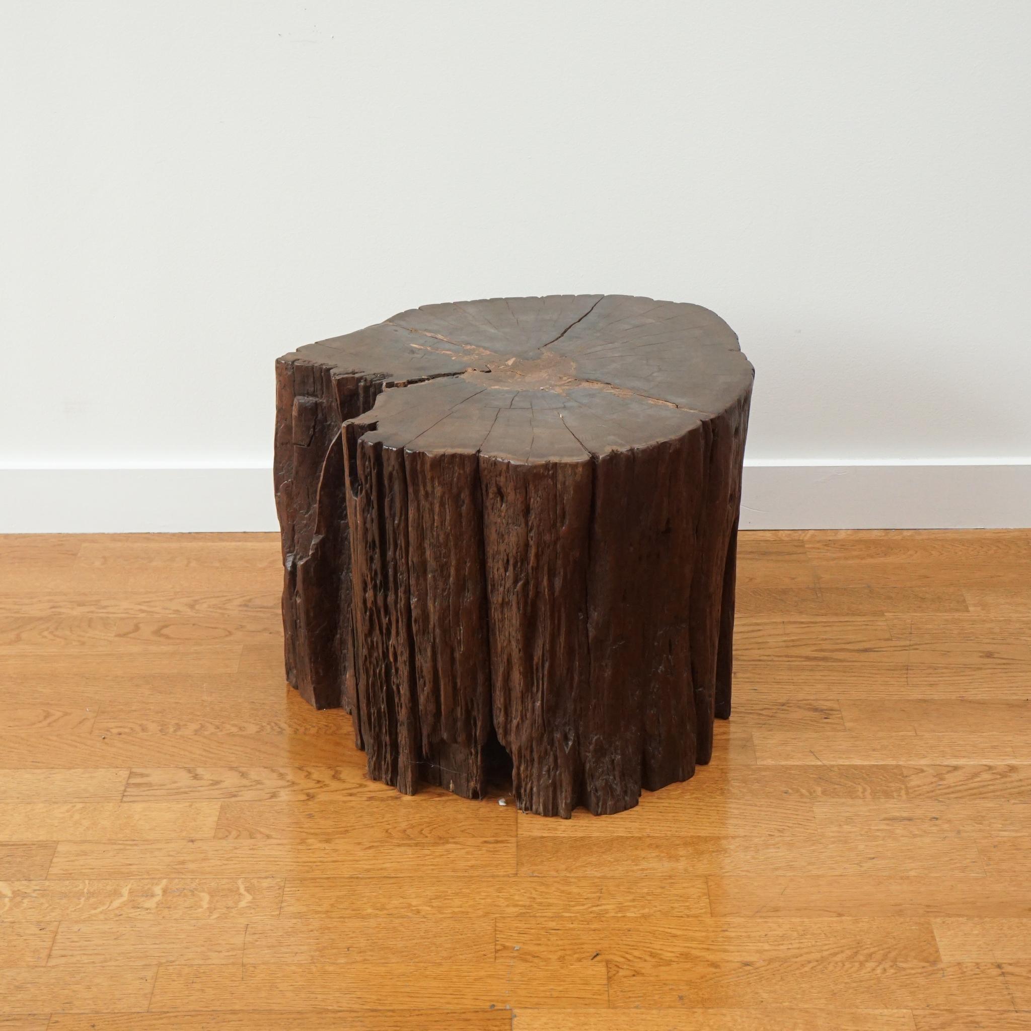 Hand-carved side table from an authentic tree trunk salvaged from Indonesia with its live edge still intact. A clear coat of wax has been applied which enhances the pattern of this incredible tables wood grain. Extremely versatile as it can be used