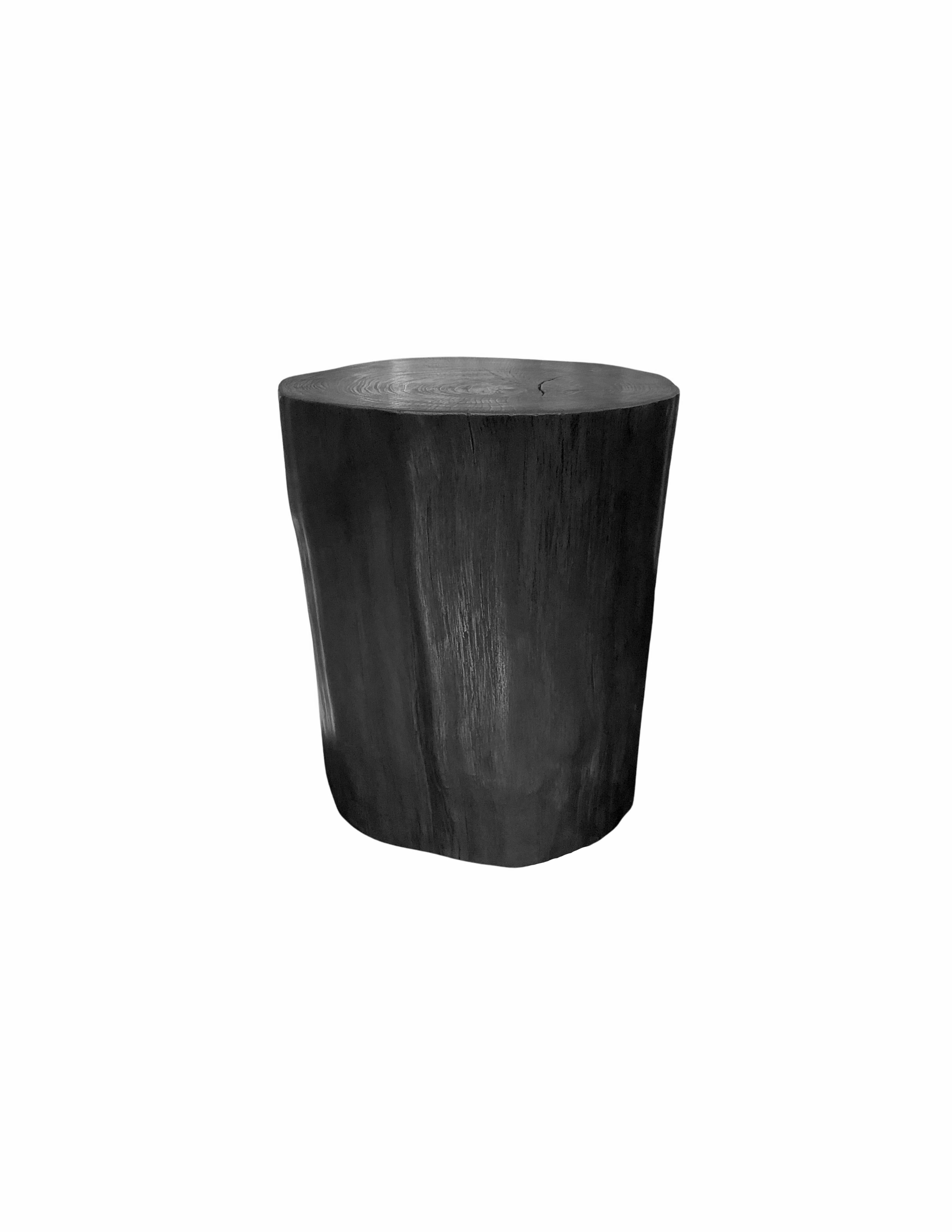 A wonderfully organic round side table. Its neutral pigment and subtle wood texture makes it perfect for any space. This table was crafted from a solid trunk of mango wood. To achieve its pigment the wood was burnt numerous times and then finished