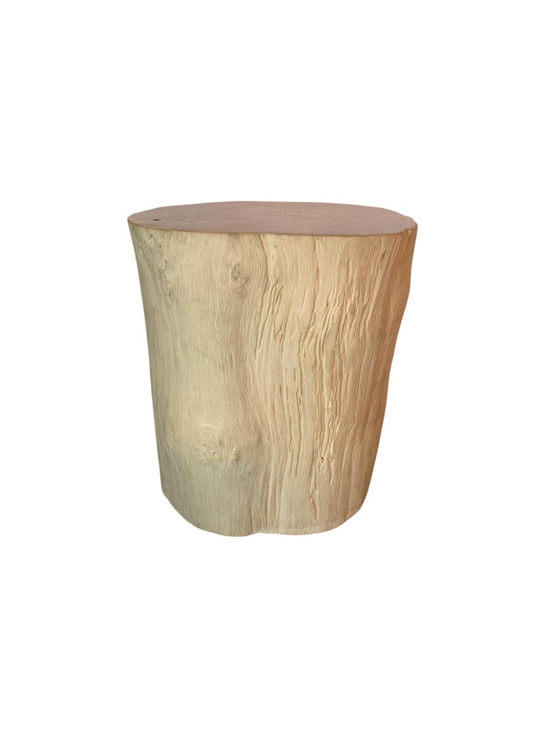A wonderfully organic round side table. Its neutral pigment and subtle wood texture makes it perfect for any space. This table was crafted from a solid trunk of teak wood. To achieve its pigment the wood was bleached on its sides numerous times and