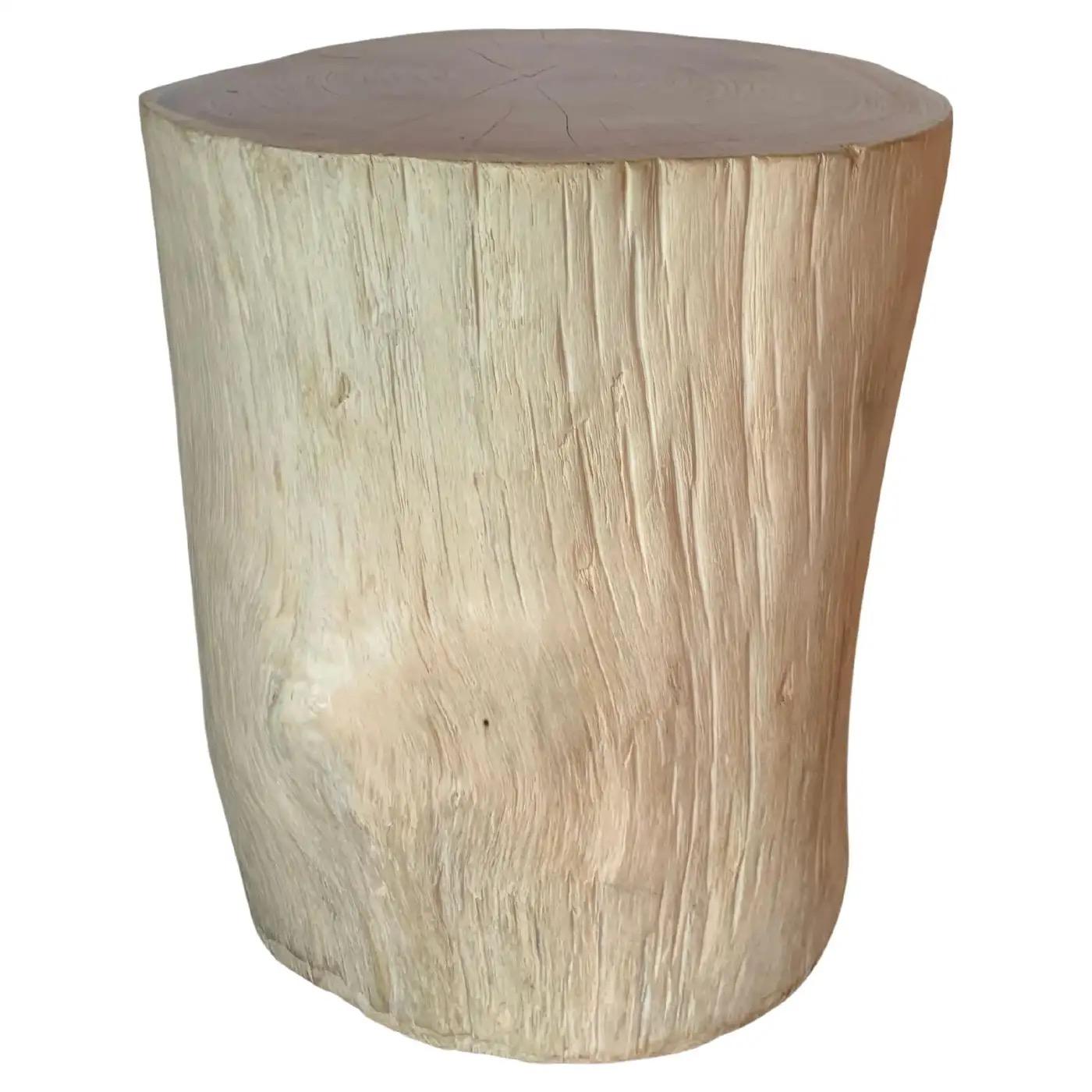 A wonderfully organic round side table. Its neutral pigment and subtle wood texture makes it perfect for any space. This table was crafted from a solid trunk of teak wood. To achieve its pigment the wood was bleached on its sides numerous times and