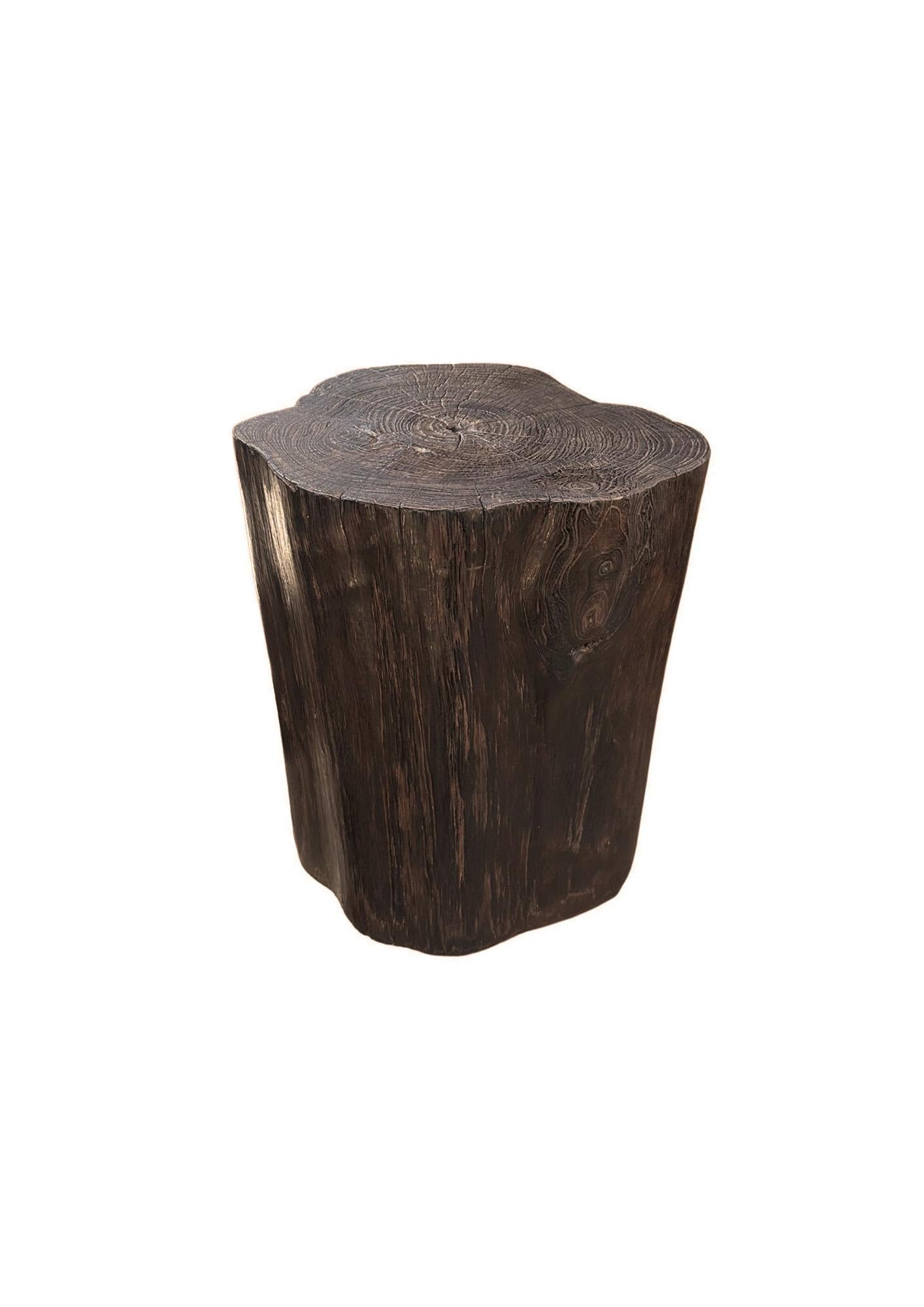 A wonderfully organic round side table. Its neutral pigment and subtle wood texture makes it perfect for any space. This table was crafted from a solid trunk of teak wood. The mix of shades and textures add to its charm. To achieve its tone the wood