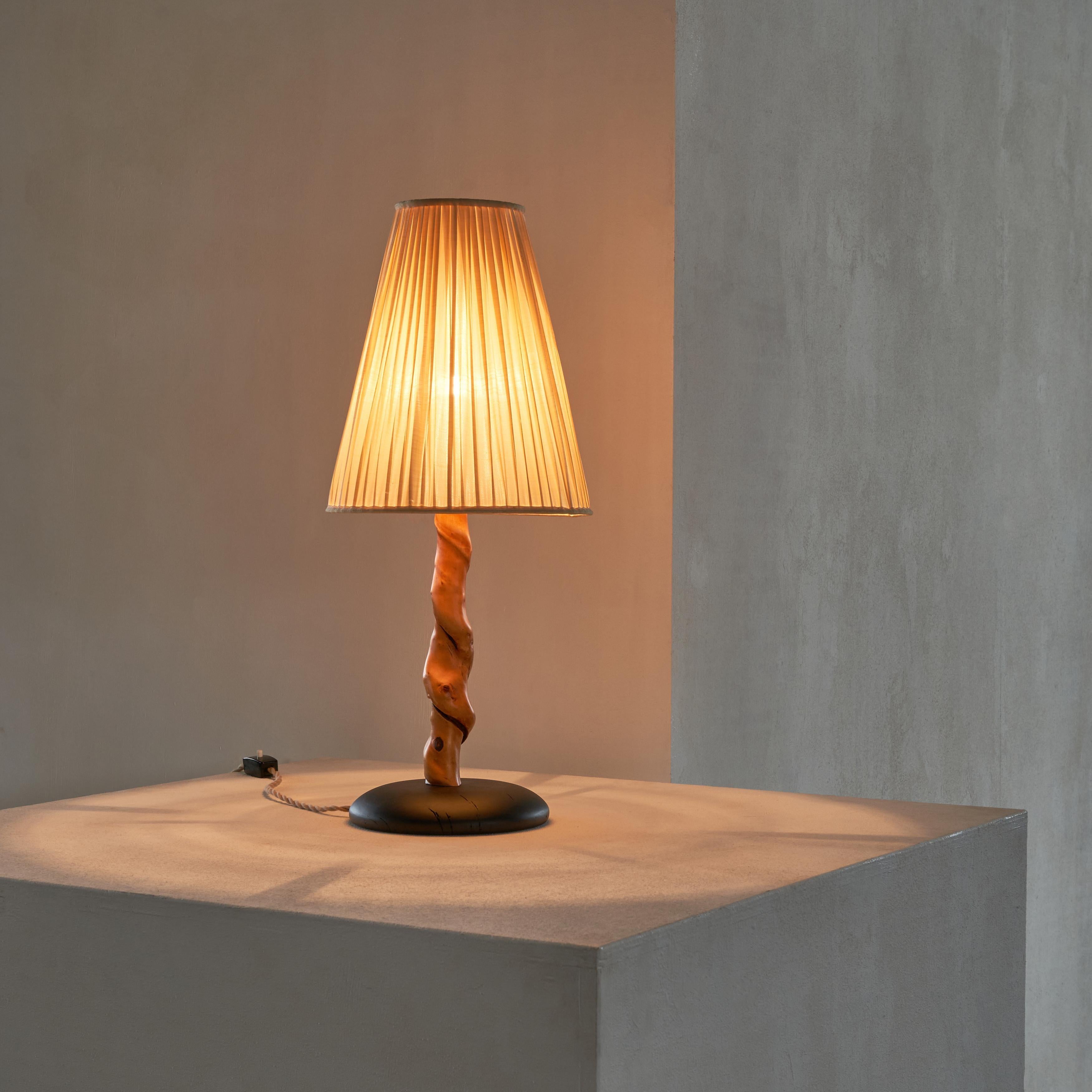 Tree Trunk Table Lamp in Acacia, Oak and Linen 1950s.

Unique and very distinct tree trunk table lamp with a vintage linen shade. Newly made base out of solid oak, which is acid-colored on a natural basis. The tree trunk is most likely from an