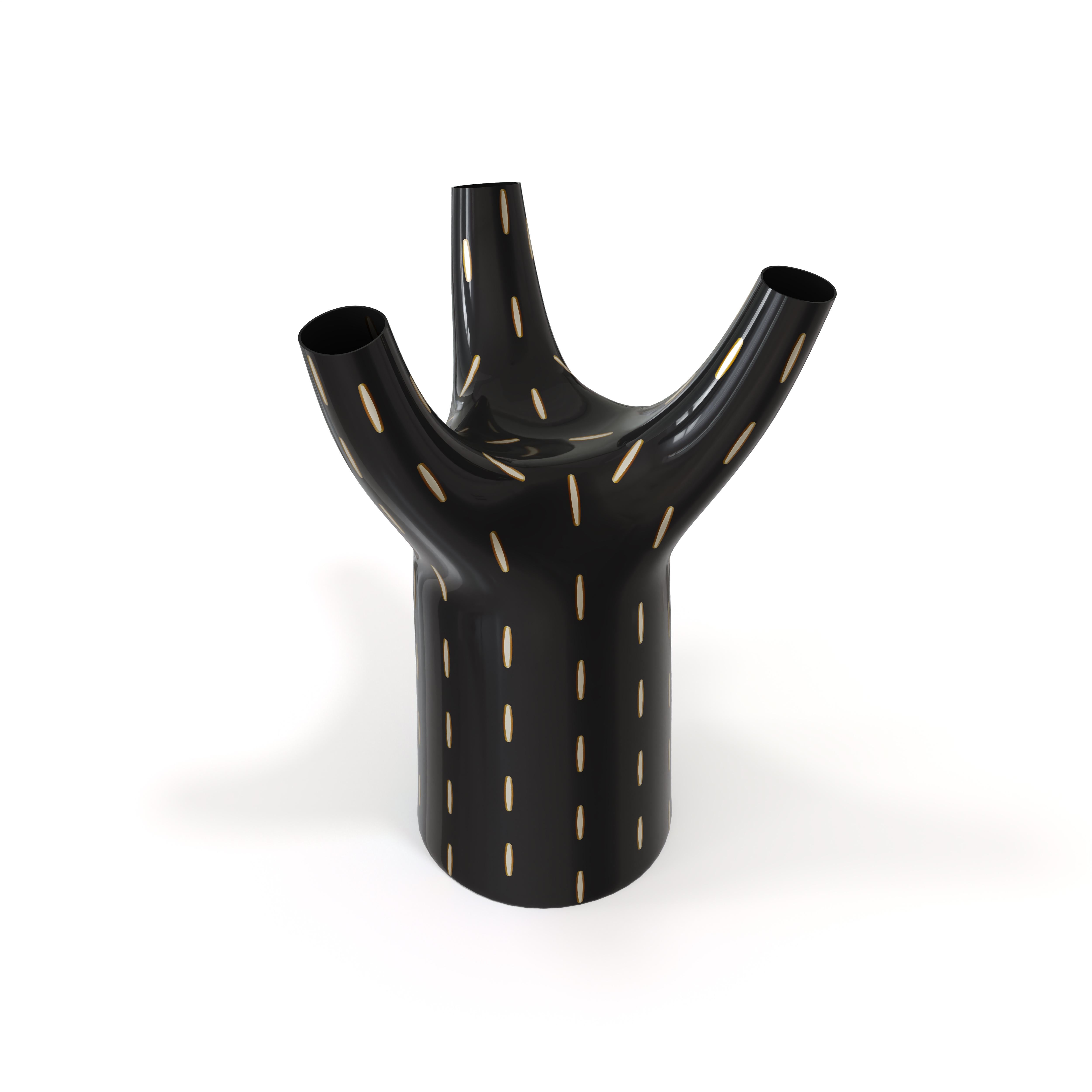 Tree Vase is an unusual shape in a vase, with intricate brass and resin inlay on black. It is fun, elegant and its three branches open up to hold flowers. 

For his debut creations, Marcantonio introduced “Vegetal Animal”, a concept that evokes