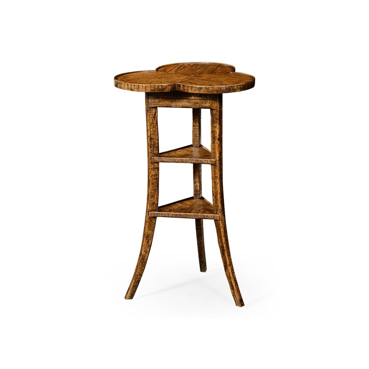 Trefoil Three-Tier Side Table, ein stark gealterter Beistelltisch mit einer dreistufigen Platte, die auf drei gespreizten Beinen um zwei dreieckige Ablagen herum montiert ist, in einer Ausführung in Landhausnussbaum.

Abmessungen: 16