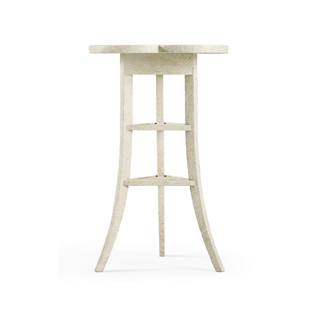Trefoil Three-Tier side table, a heavily distressed side table with a trefoil top mounted on three splayed legs around two triangular shelves in a whitewash finish.

Dimensions: 16