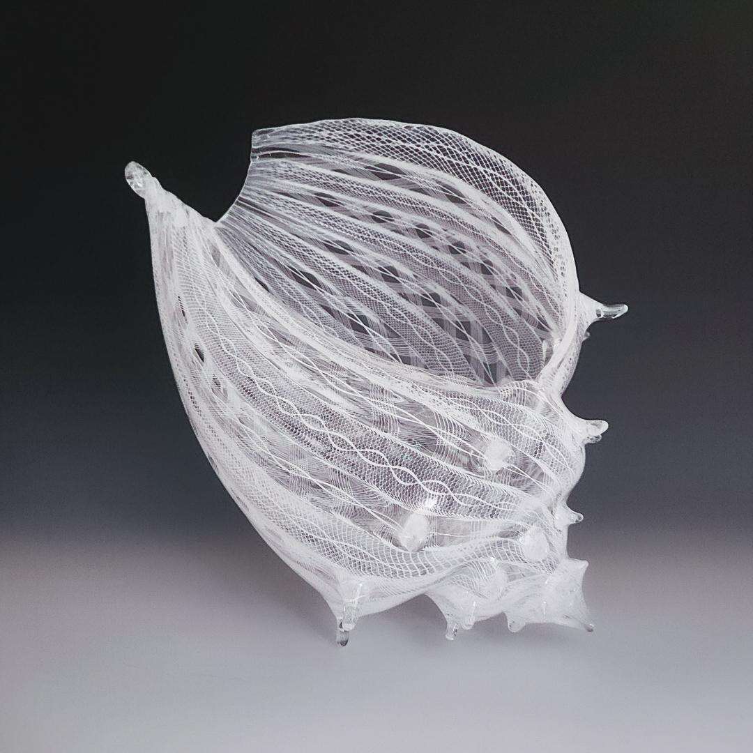"XL Latticino Conch" is a hand-blown glass clear and white conch shell. 