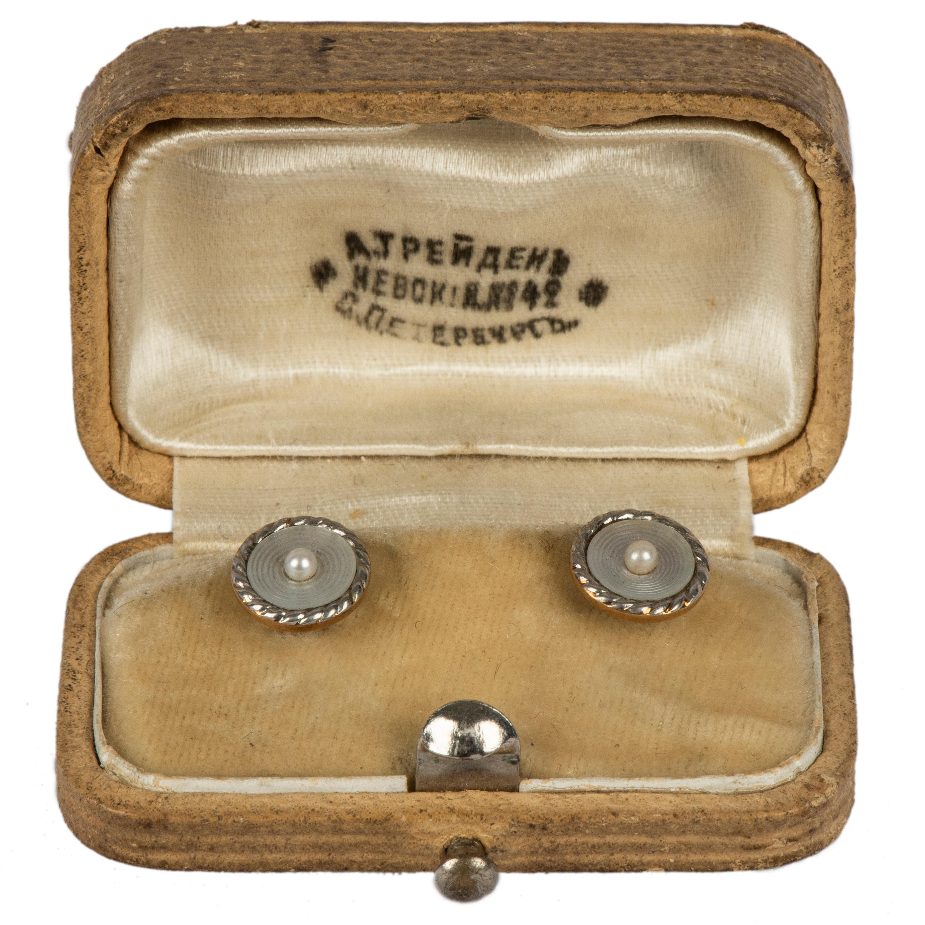 This pair of Russian prerevolutionary gold shirt studs was made in the imperial capital of St. Petersburg, during the reign of Tsar Nicholas II and retailed by the renowned jeweler to the court, Alexander Treiden. Designed as concentric white enamel