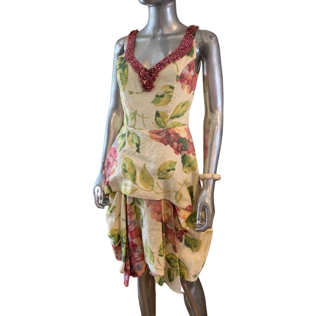 This dress is spectacular. Designed by New Zealand designer Trelise Cooper (the line is carried at Saks Fifth Avenue. The dress has an original floral print in 100% linen.  The v neck is hand beaded with real gemstones! We don’t know what kind of