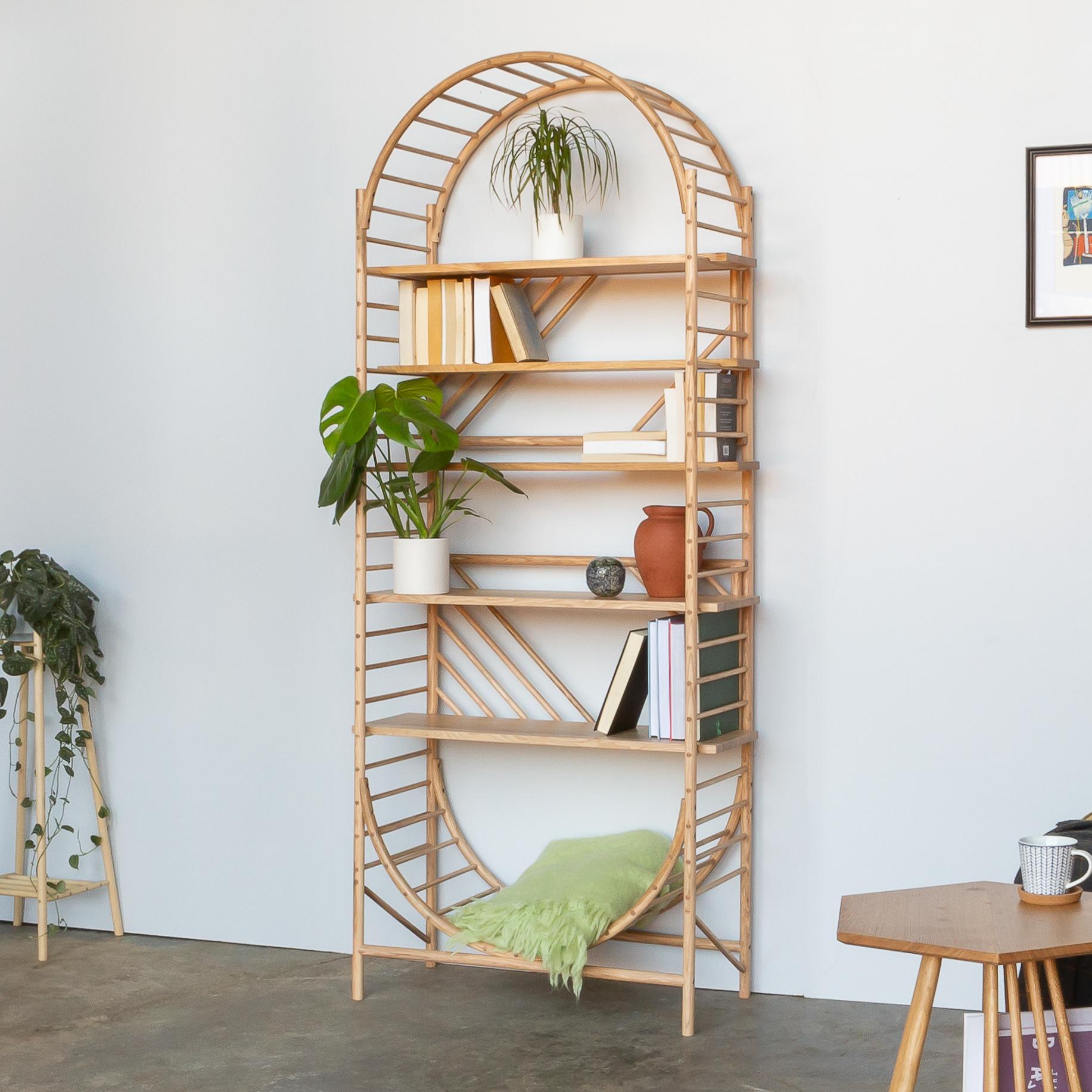 TRELLIS Shelving was designed to be a freestanding shelving system handcrafted from solid and steam bent wood, that could be used as a room divider, accessible from both sides and easily customisable by the user. To create a substantial piece of