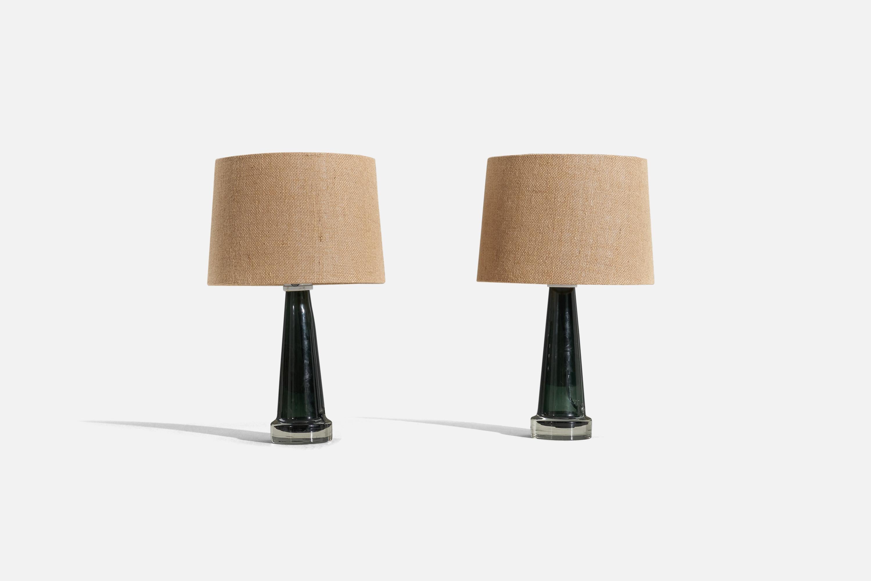 A pair of green glass table lamps, designed and produced by Trema, Småland, Sweden, c. 1950s.

Sold without lampshade. 
Dimensions of Lamp (inches) : 11.25 x 3.5 x 3.5 (H x W x D)
Dimensions of Shade (inches) : 7.1875 x 10 x 10 (T x B x S)
Dimension