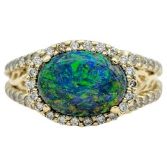 Tremonti East-West Oval Cut Black Opal Ring with Diamond Halo in 14 Karat Gold
