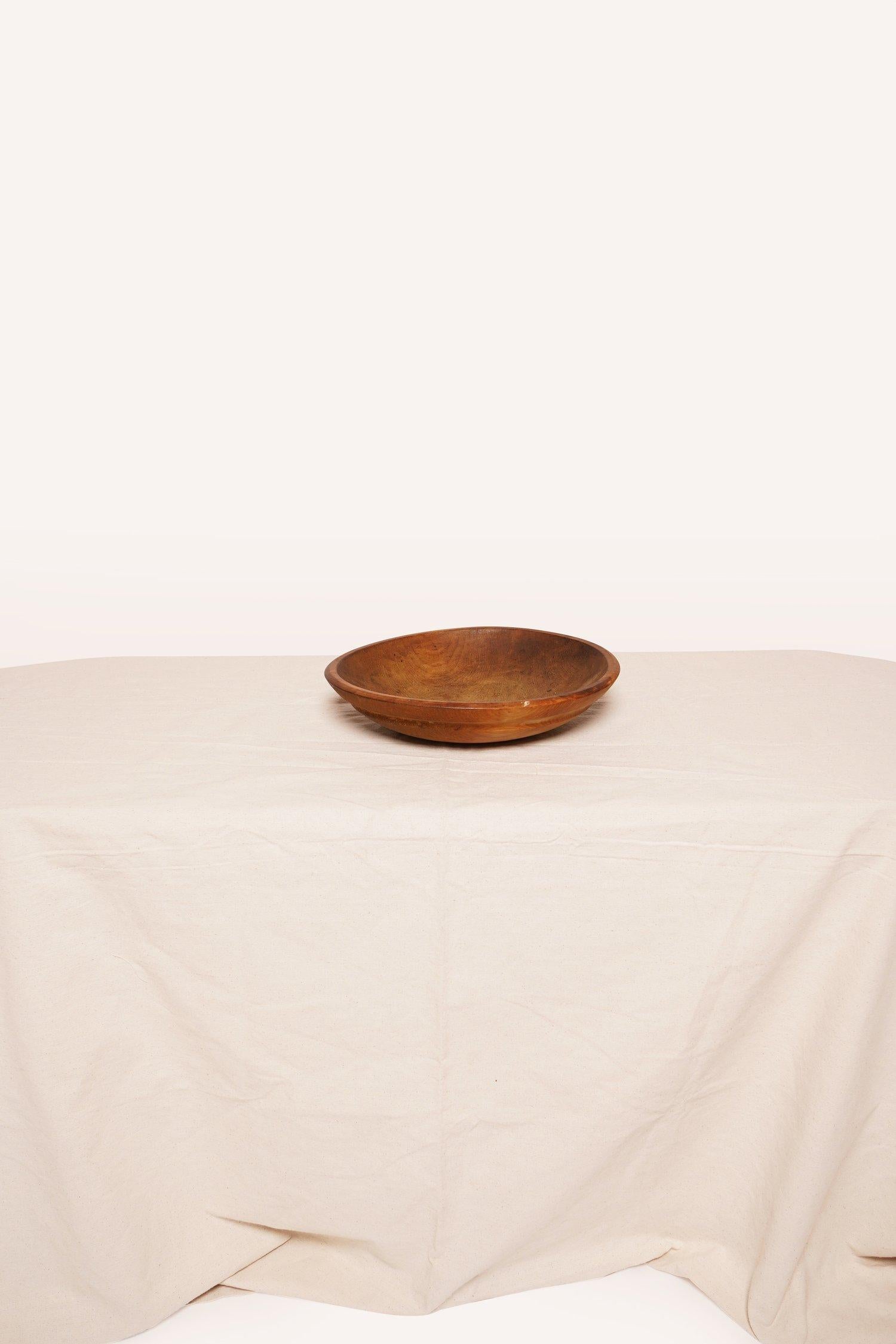 This trencher round wooden dough bowl was traditional used to prepare dough in the 19th century. This bowl can be used for storage or displaying as is.
