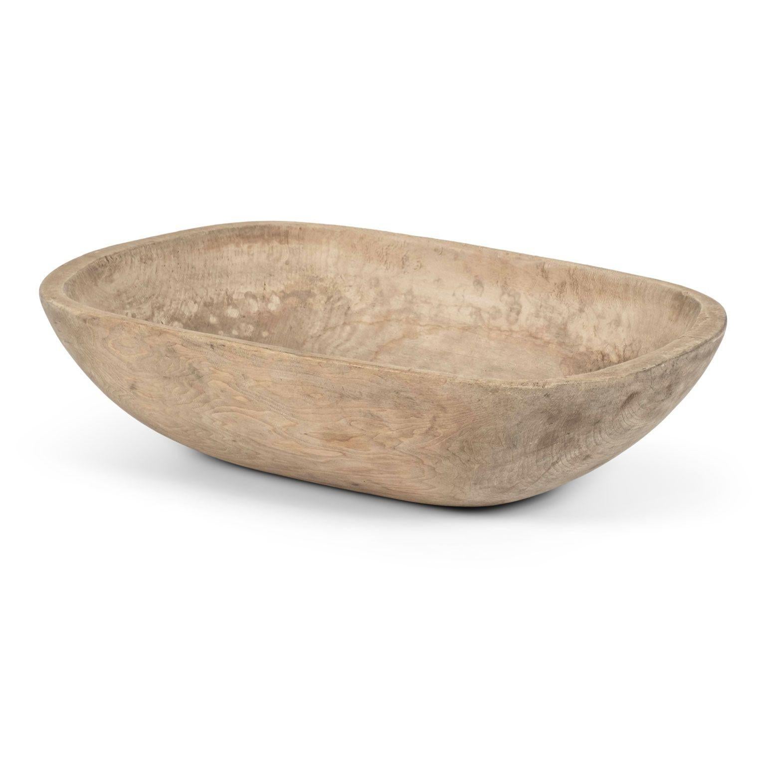 Trencher-shaped rustic Swedish pine dug out bowl hand-carved circa 1820-1859. Dry, pale light grayish brown color finish. Inscribed with a faint single runic character.

Note: When shipped, antique wood may shrink and/or split along its grain due to