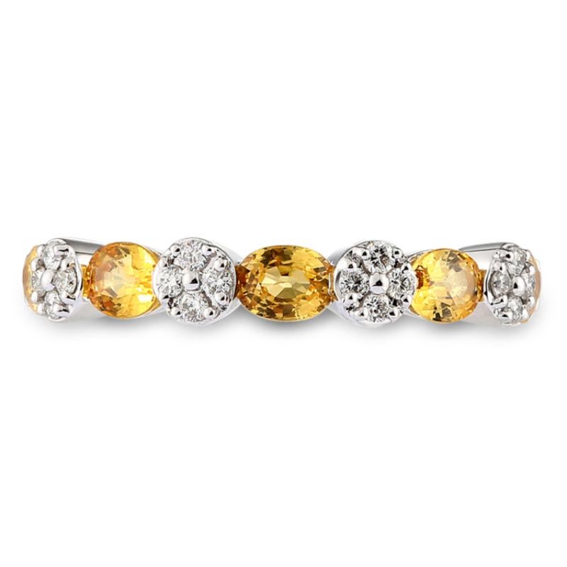 Trendy 18 Karat White Gold and Yellow Sapphire Diamond Ring.

Diamonds of approximately 0.14 carats, yellow sapphires of approximately 1.14 carats mounted on 18 karat white gold ring. The ring weighs approximately 3.29 grams.

Please note: The