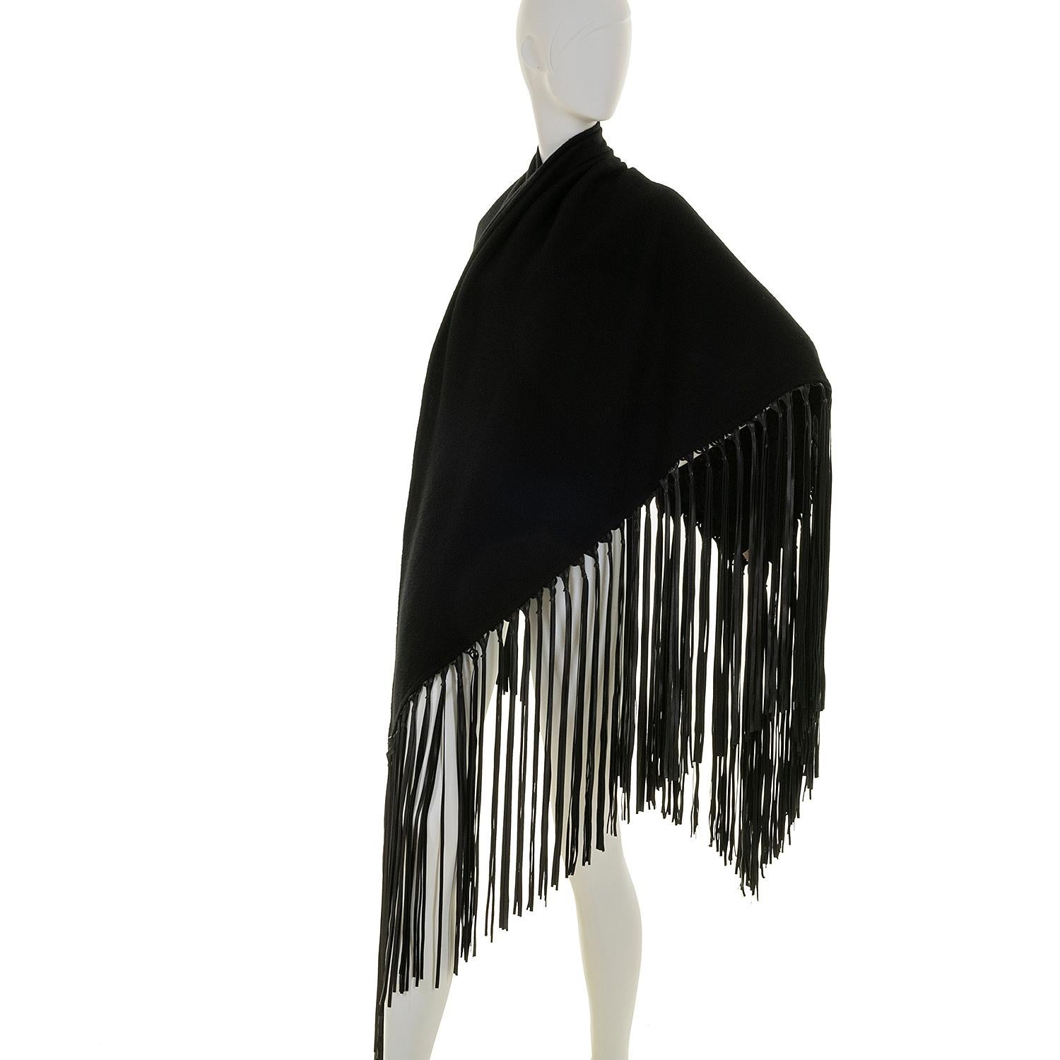 This elegant Hermes Shawl is perfect for the Fall and Winter seasons. In perfect condition, the shawl is 70% cashmere and 30% wool, giving you the warmth but with the luxury feel of cashmere. Trimmed with a black leather tassel fringe, this