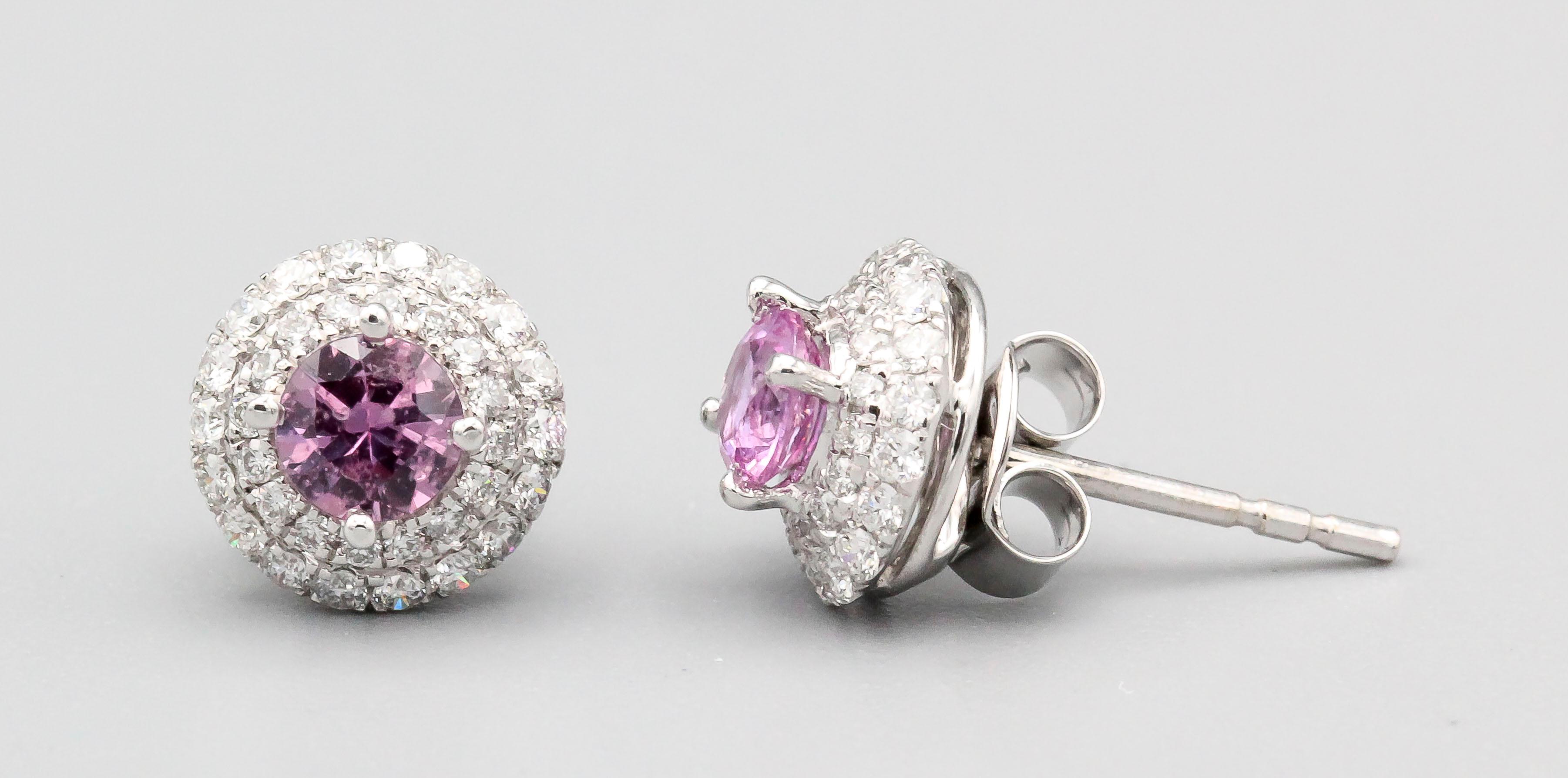 Fine pair of pink sapphire and diamond earrings set in 18k white gold, by Tresorra. They feature high grade round brilliant cut diamonds of approx. .5 carats and .85 carats of vibrant pink sapphires. Expert workmanship and easy to wear.  Retail
