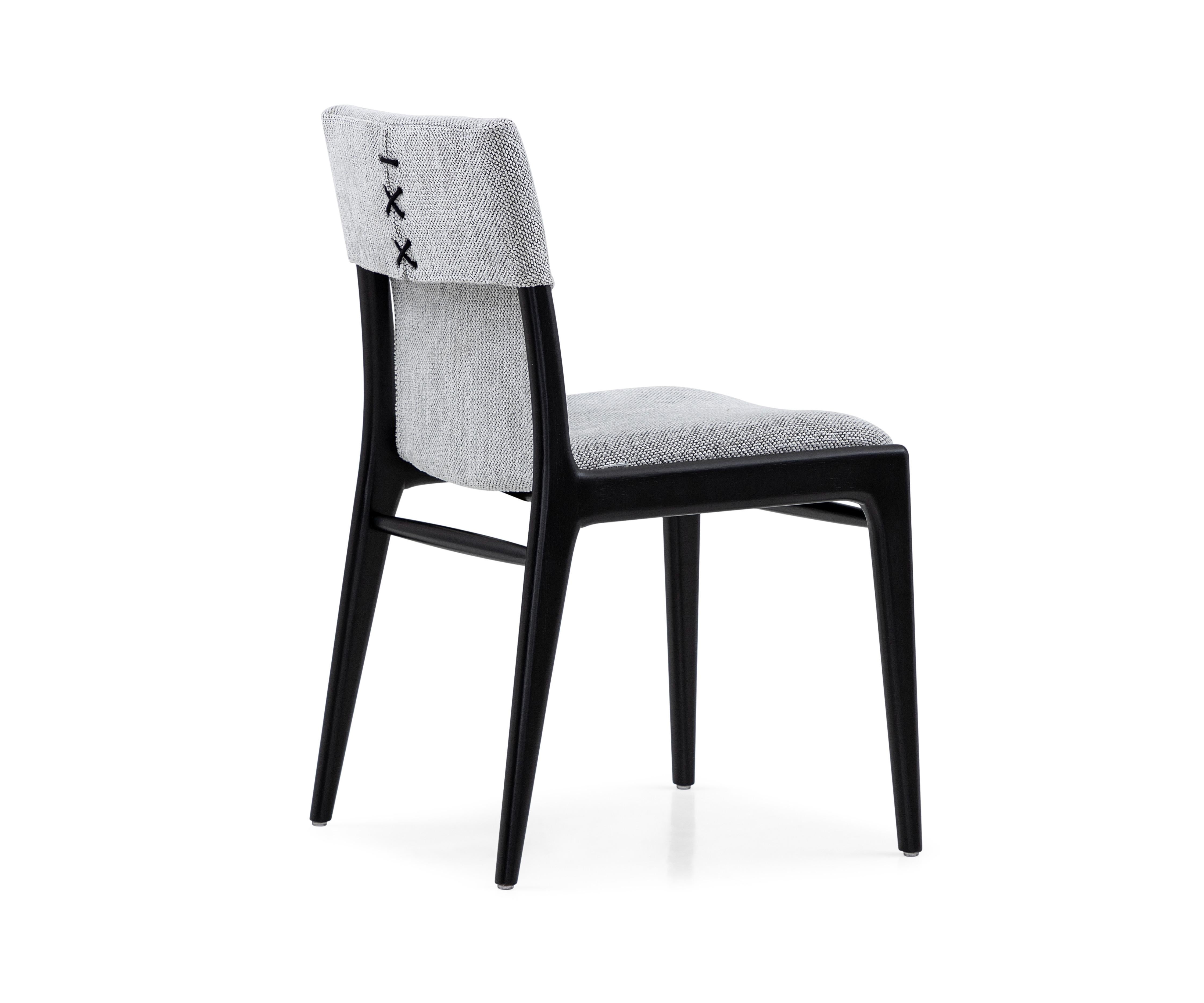 Legendary Uultis designer Mr. Sergio Batista has created the Tress dining chair in a gray fabric upholstered and black wood finish. His creations are synonymous with style, elegance, comfort, and quality. With the Tress chair, Mr. Batista has